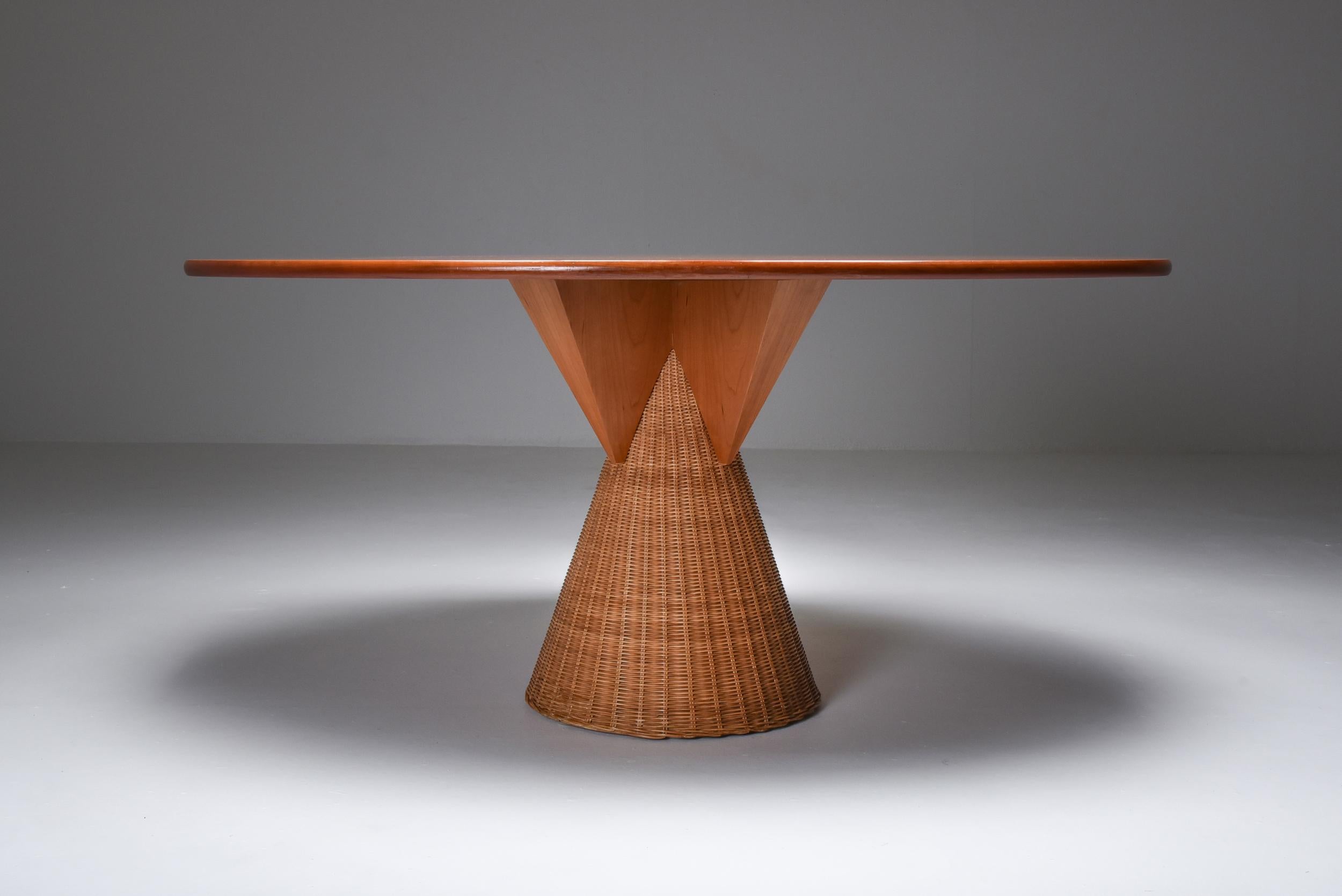 Oval dining table, cherry, rattan, post-modern, Bonacina, Italy 1970s

Interesting combination of materials make this an architectural piece which could fit in a variety of interiors.
The use of rattan or woven cane balances out the more hard