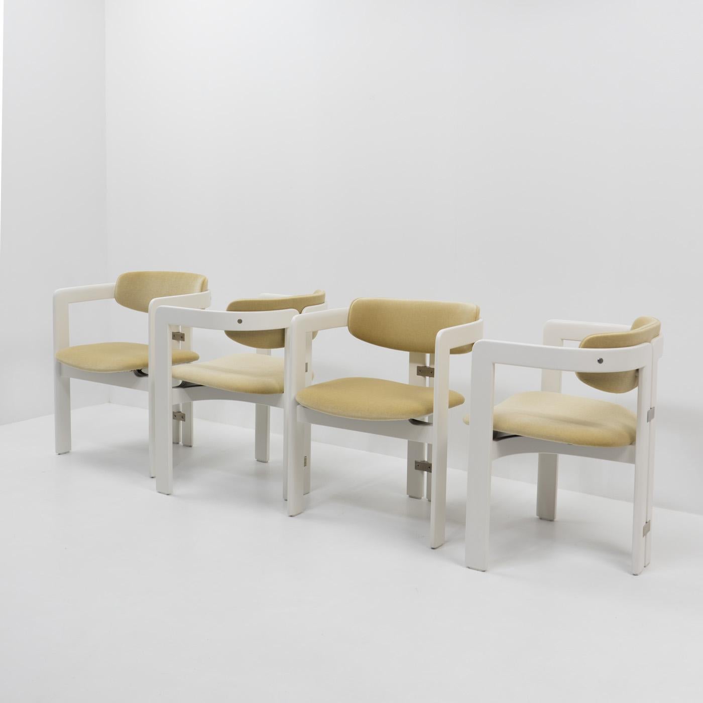 Set of four “Pamplona” dining chairs by Augusto Savini for Pozzi, featuring a white wooden frame with natural mohair upholstery.

The Pamplona chair is a timeless and iconic piece of furniture, designed by the renowed Italian architect and designer,