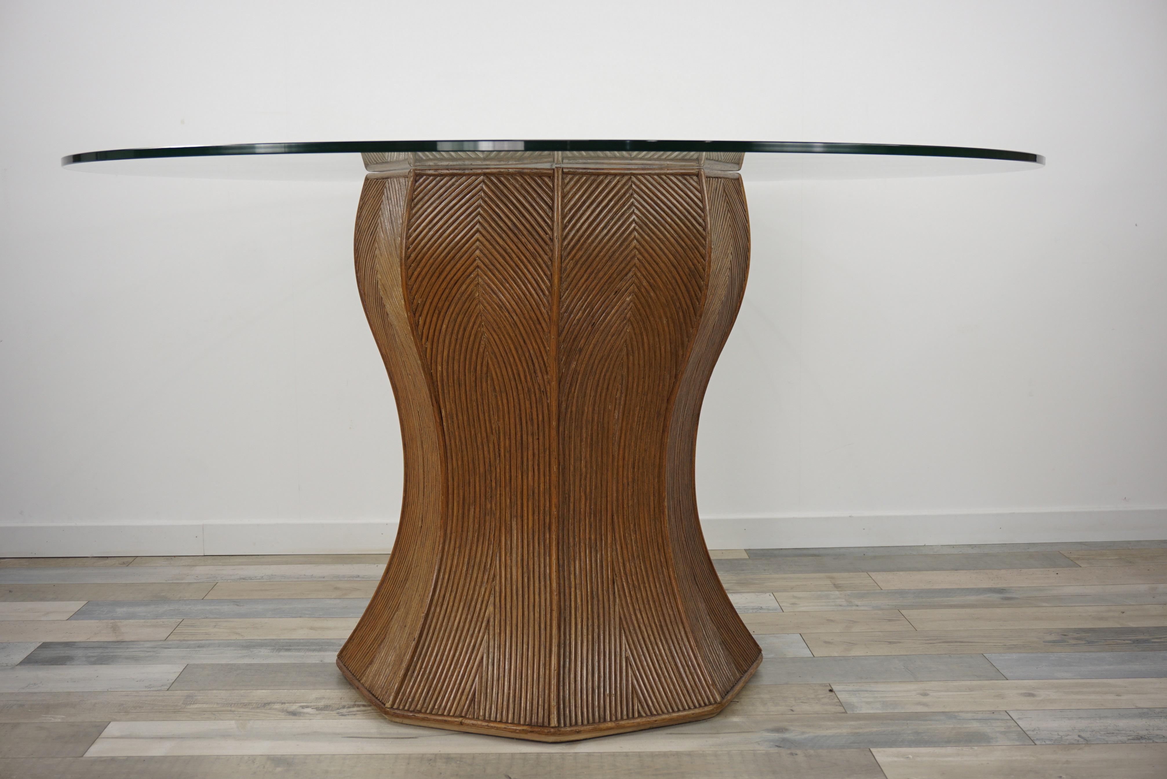Italian design round pedestal dining table consisting of a generous curved cylindrical (diameter 58cm) and graphic pencil reed base with a round glass top.