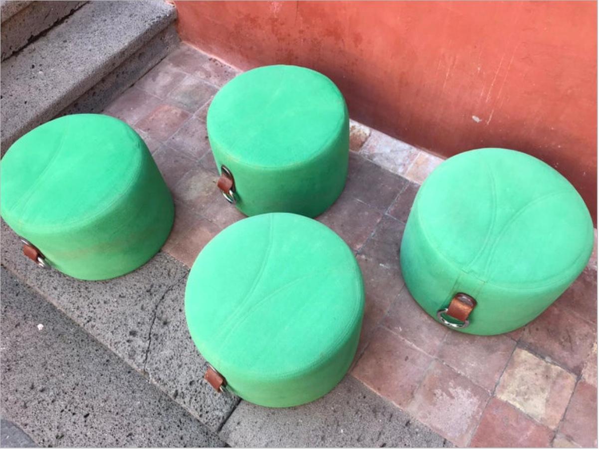 Stylish modern Italian design  poufs designed by Guido Faleschini for Hermès, Hermès tan leather handles, green suedine upholstery. These pieces were displayed and available for custom order at select Hermès retail locations in the 1970s. 
Three