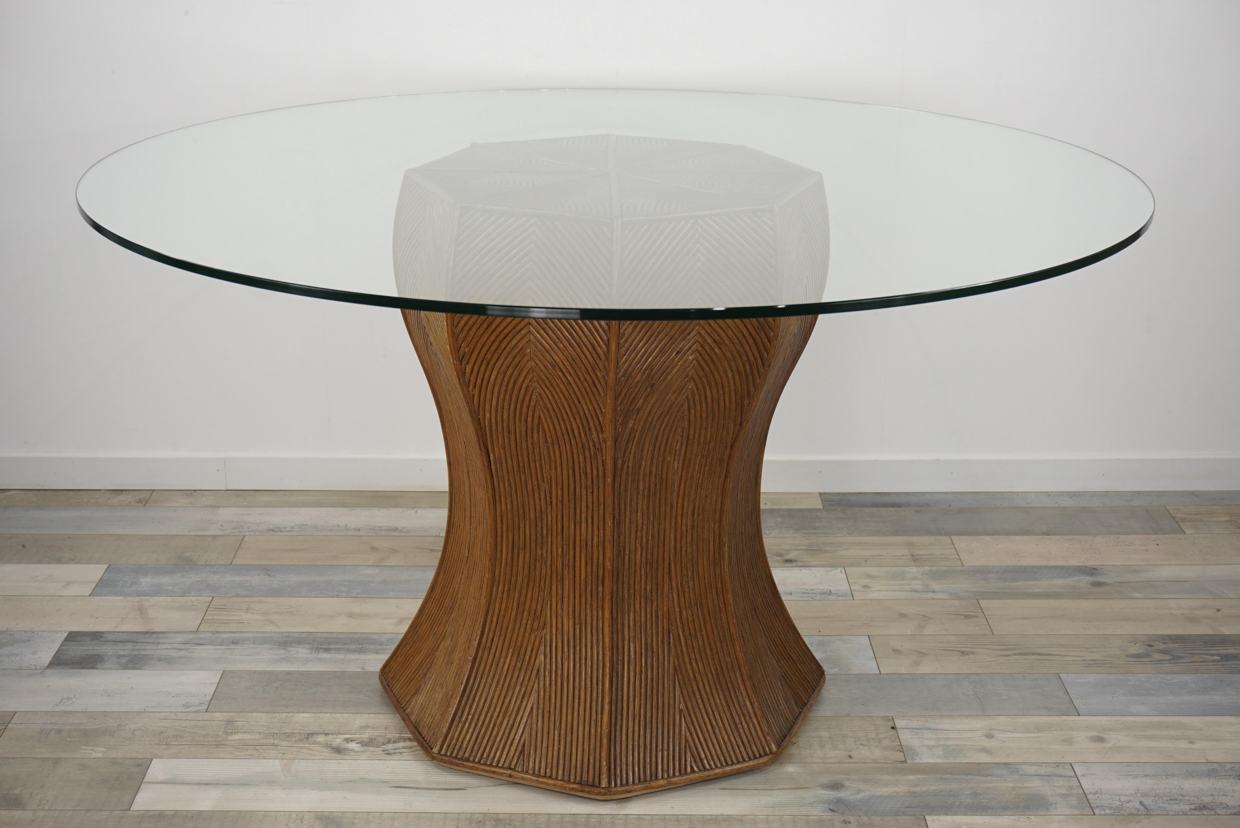 Italian design round pedestal dining table consisting of a generous curved cylindrical (diameter 58cm) and graphic pencil reed base with a round glass top.