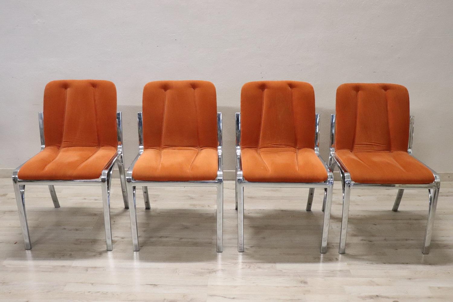 Italian design lovely set of four dining room chairs, 1970s. The chairs are comfortable with a seat orange velvet. The structure is in chromed metal. These chairs are perfect for the modern home. Used, good conditions see photos.

