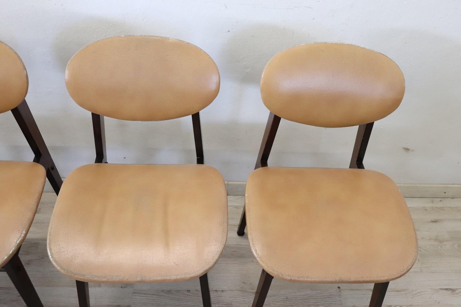 Italian design lovely set of six dining room chairs, 1960s. The chairs are comfortable with a seat in faux leather. The structure is in beech wood. These chairs are perfect for the modern home. Used conditions with widespread signs of wear in the