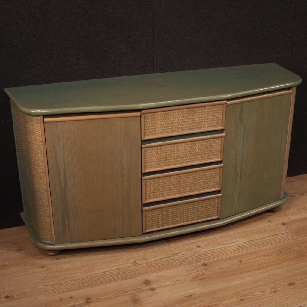 Sideboard of Italian design from the 1980s. Furniture in exotic wood adorned with woven wood on the doors of beautiful line and good utility. Sideboard a two doors side and four central drawers of excellent capacity. Furniture of beautiful