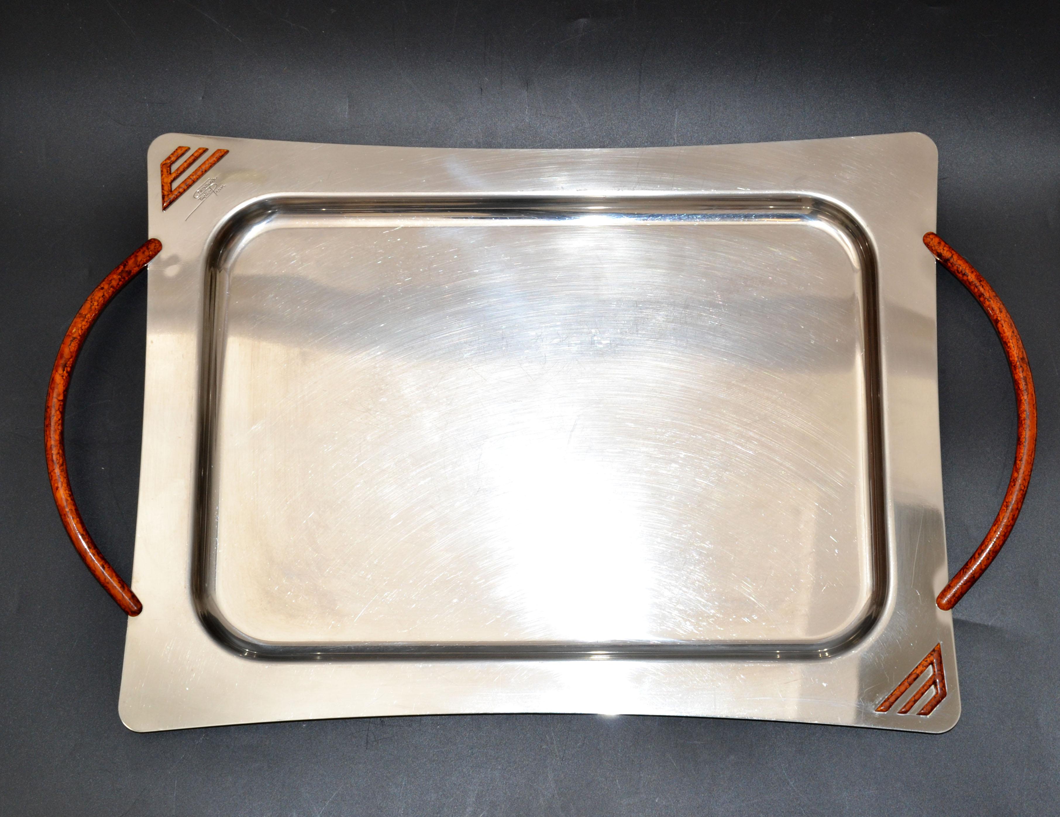 Mid-Century Modern decorative serving tray or platter made out of stainless steel with Resin handles made in Italy by Design Studio Pran.
Marked on Top Design Studio Pran and at the base. Inox pran Mod. Despositato.
Serving Space is 14 x 10 inches.