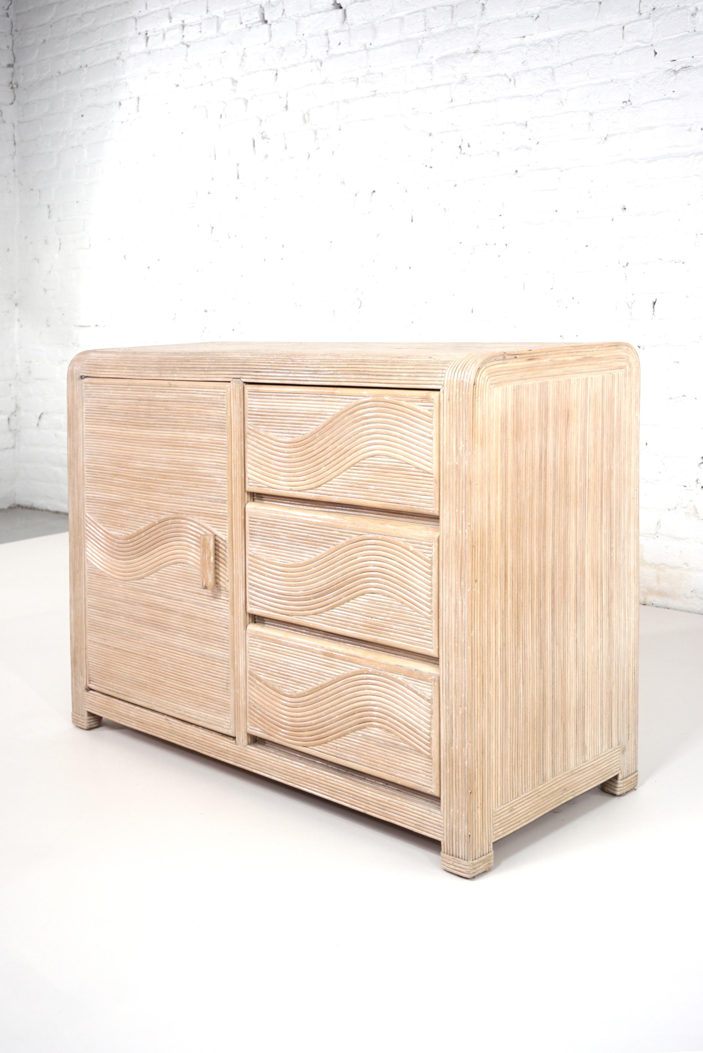 Italian design sideboard consisting of a generous curved wooden structure adorned with graphic pencil reed cerused effect consisting of a shelves spaces and drawers.