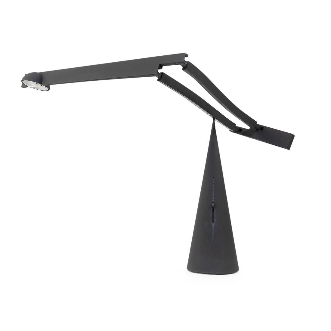 Pivoting table lamp designed by Mario Barbaglia and Marco Colombo during the 1980s. 

The table lamp has a balancing arm that pivots on top of a conical base; the arm itself can be extended as well. Light intensity is adjusted using the slider