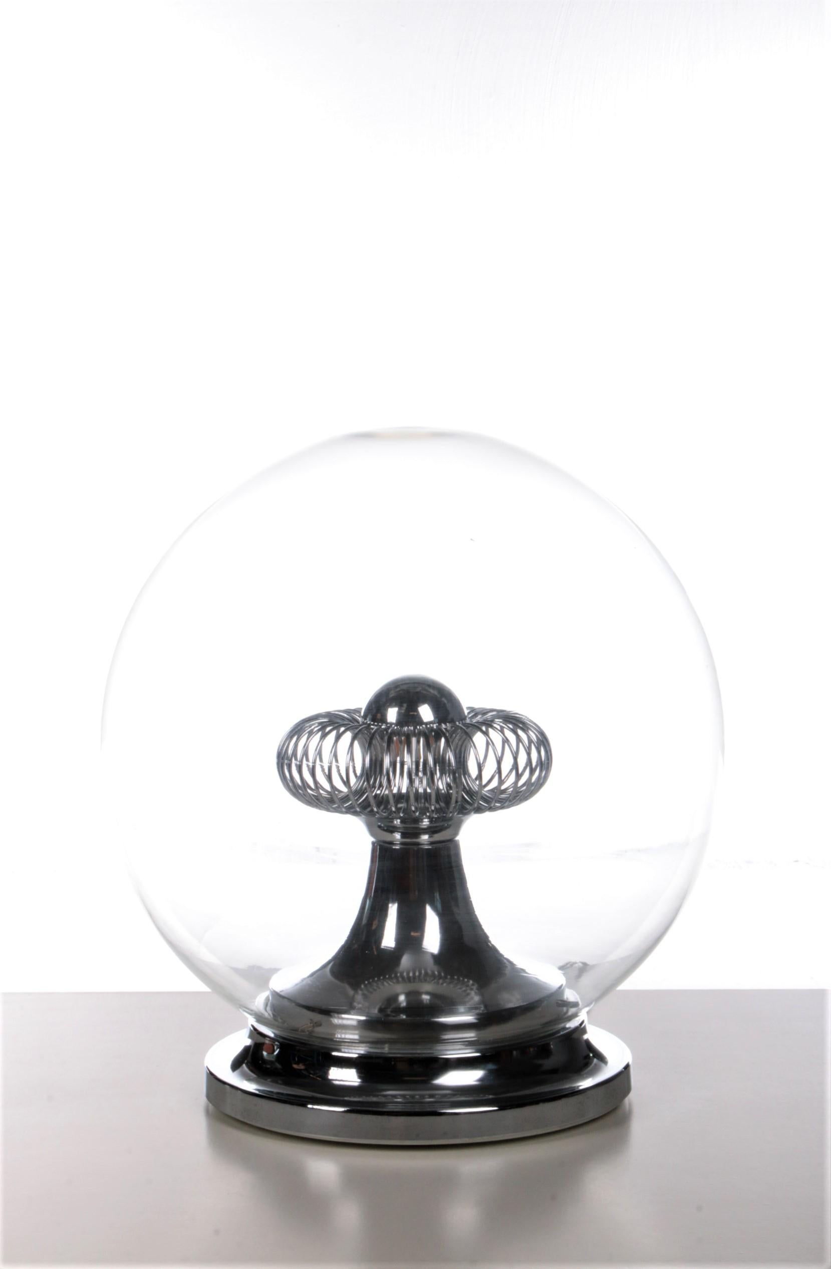 This is a beautiful table lamp made in Italy.

Made of a chrome base with a beautiful glass globe.

We have put in a head mirror LED lamp and there is a chrome spiral around the lamp.

The lamp can be exchanged because the bottom can be easily