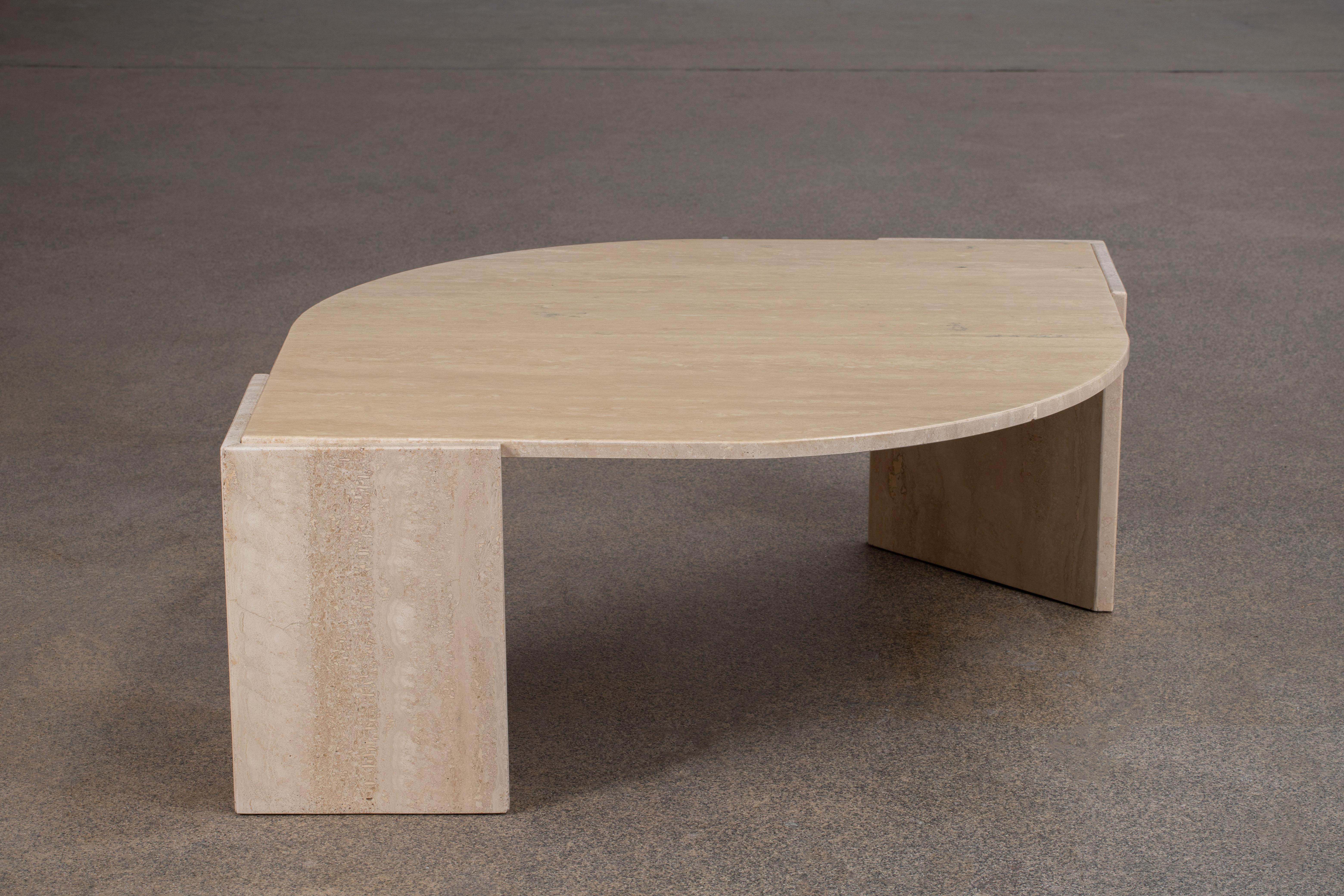 Beautiful travertine table.

The heavy eye-shaped top rests on two marble V blocks.