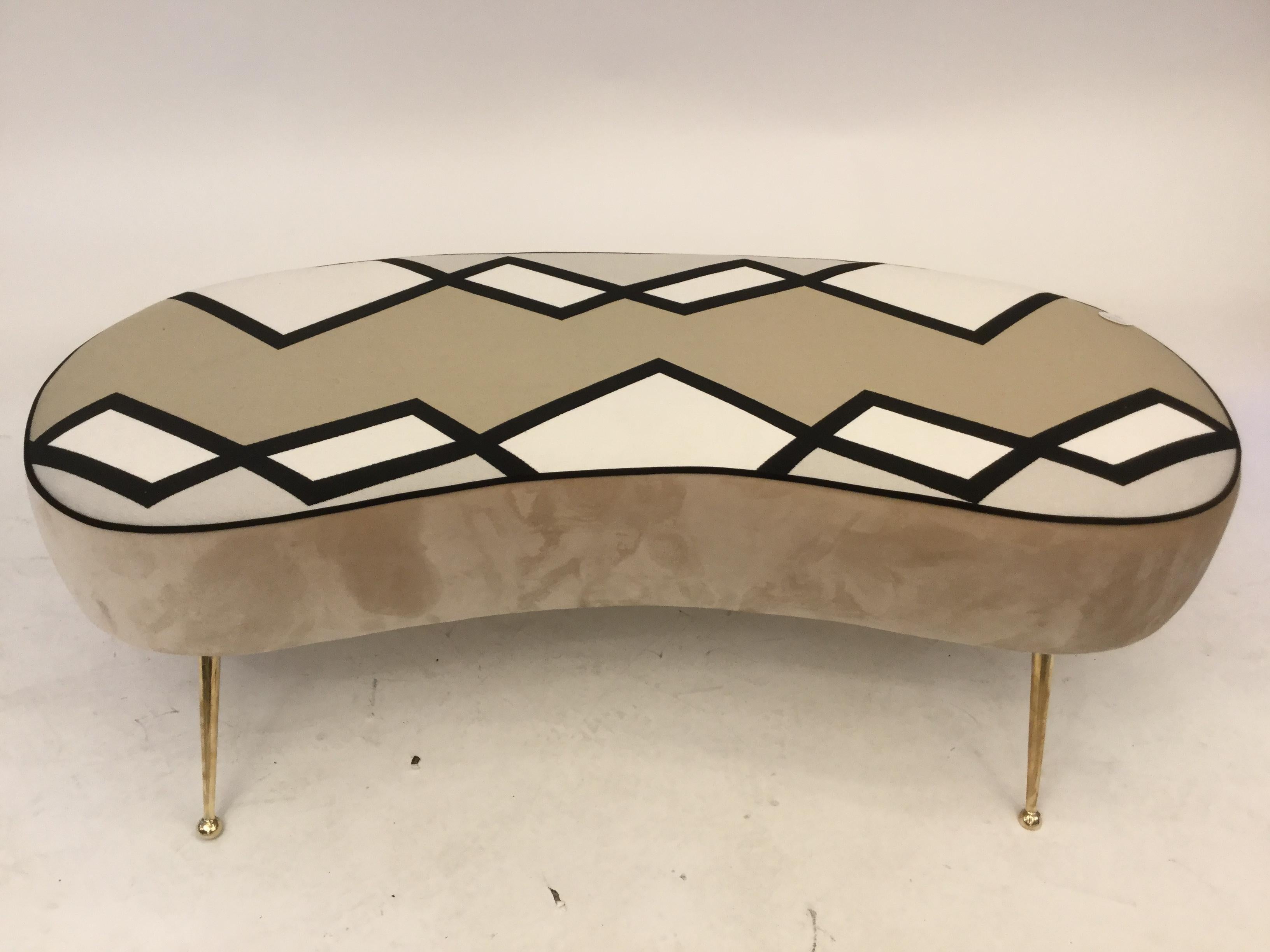 An Italian designed bean shaped bench reupholstered in velvety fabric on brass legs leading to ball feet with a geometric motif midcentury design.