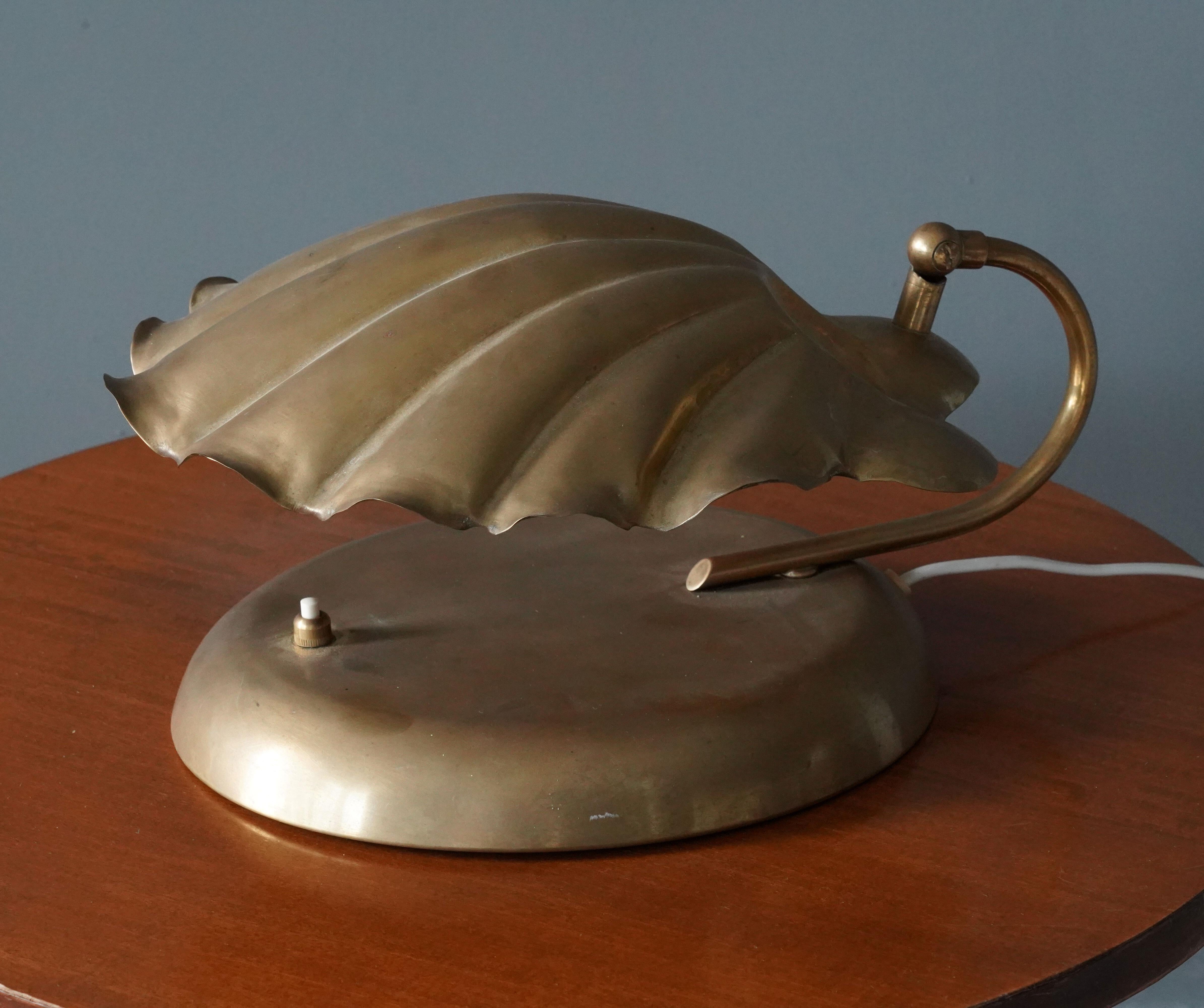 A table lamp designed and produced in Italy, 1960s-1970s. In brass.

Other designers of the period include Max Ingrand, Angelo Lelii, Paul Evans, Gabriella Crespi, and Paavo Tynell.