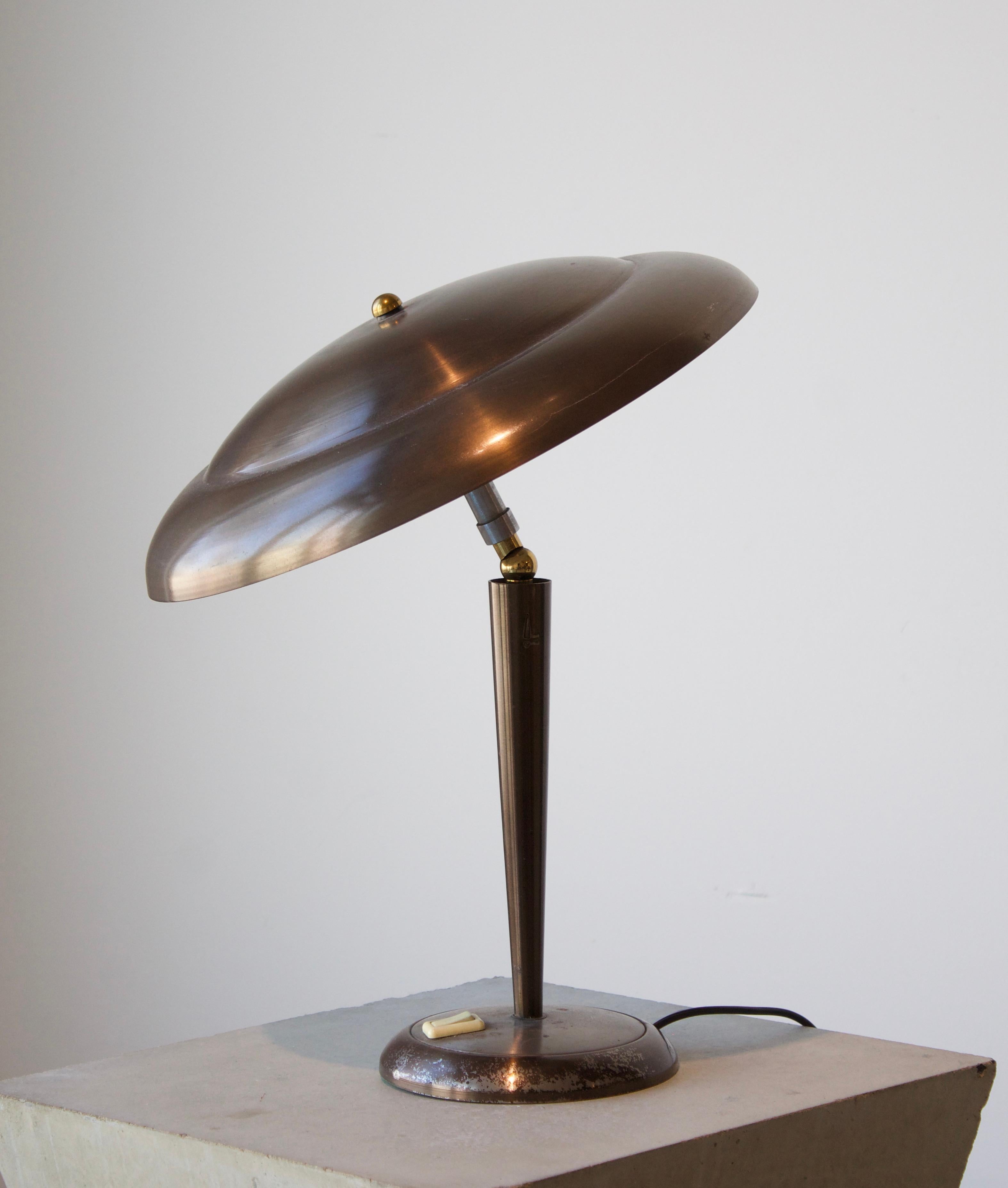 A table lamp. Designed and produced in Italy, 1950s. In brass with metal hardware. 

Other designers and makers of the period include Gabriella Crespi, Maria Pergay, Max Ingrand, Stilnovo, and Fontana Arte.
