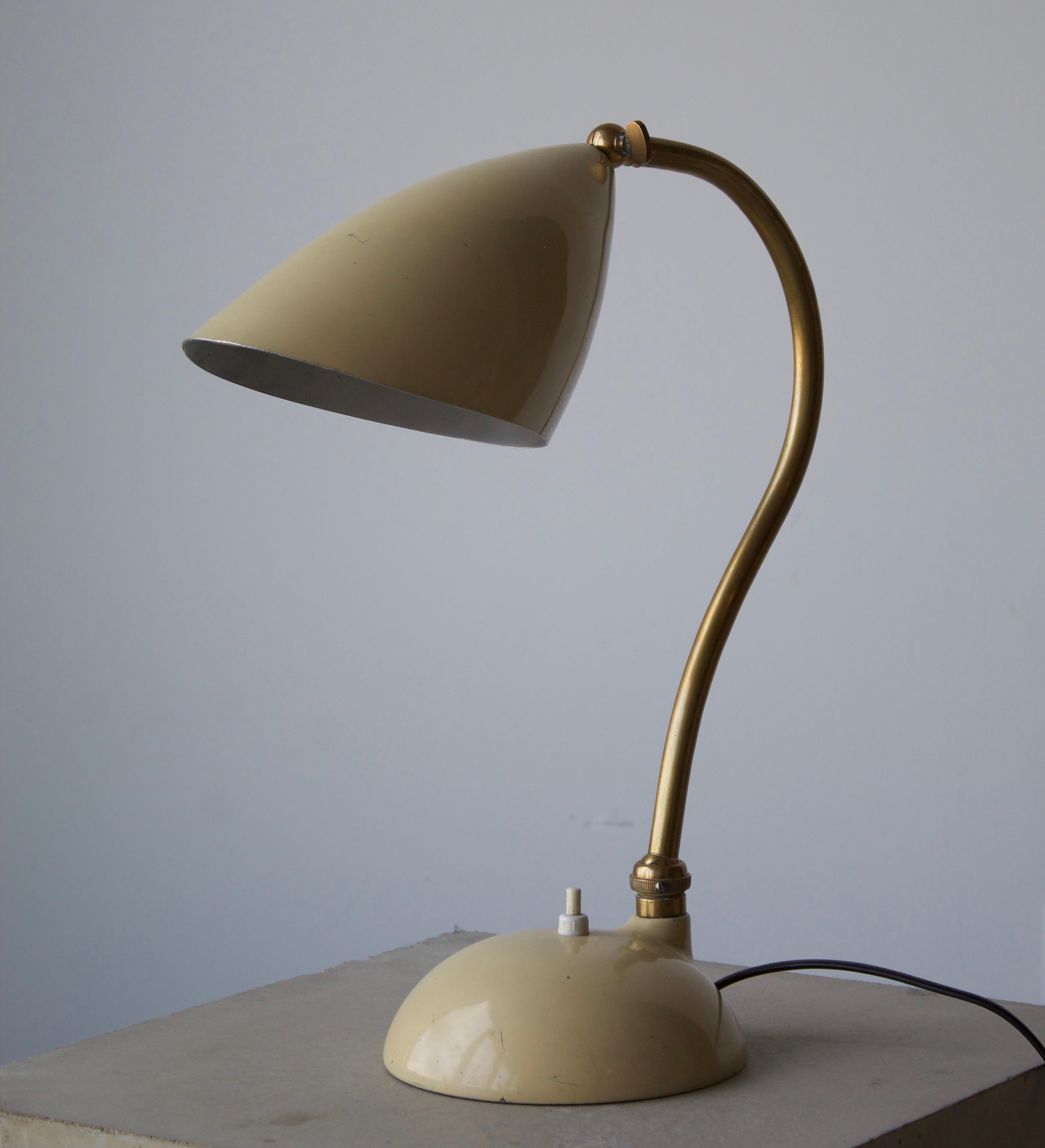 A table lamp / desk light. Designed by an unknown Italian designer. Produced in Italy, 1950s. brass base, white lacquered metal screen and base. 

Other Italian lighting designers of the period include Angelo Lelii, Max Ingrand, Gino Sarfatti, and