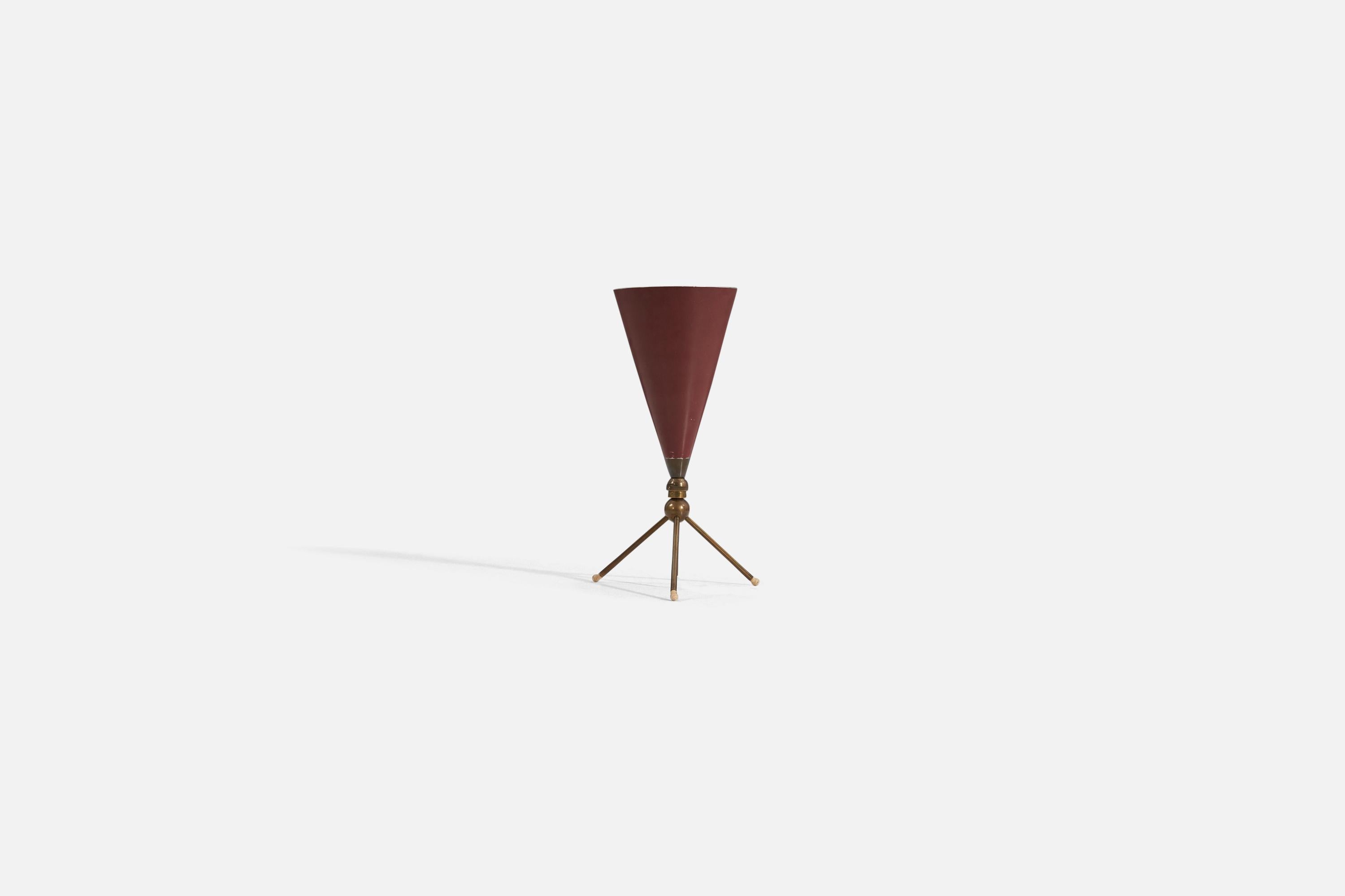An adjustable table lamp designed and produced in Italy, 1950s. The lamp features a brass base with a red-lacquered metal shade.