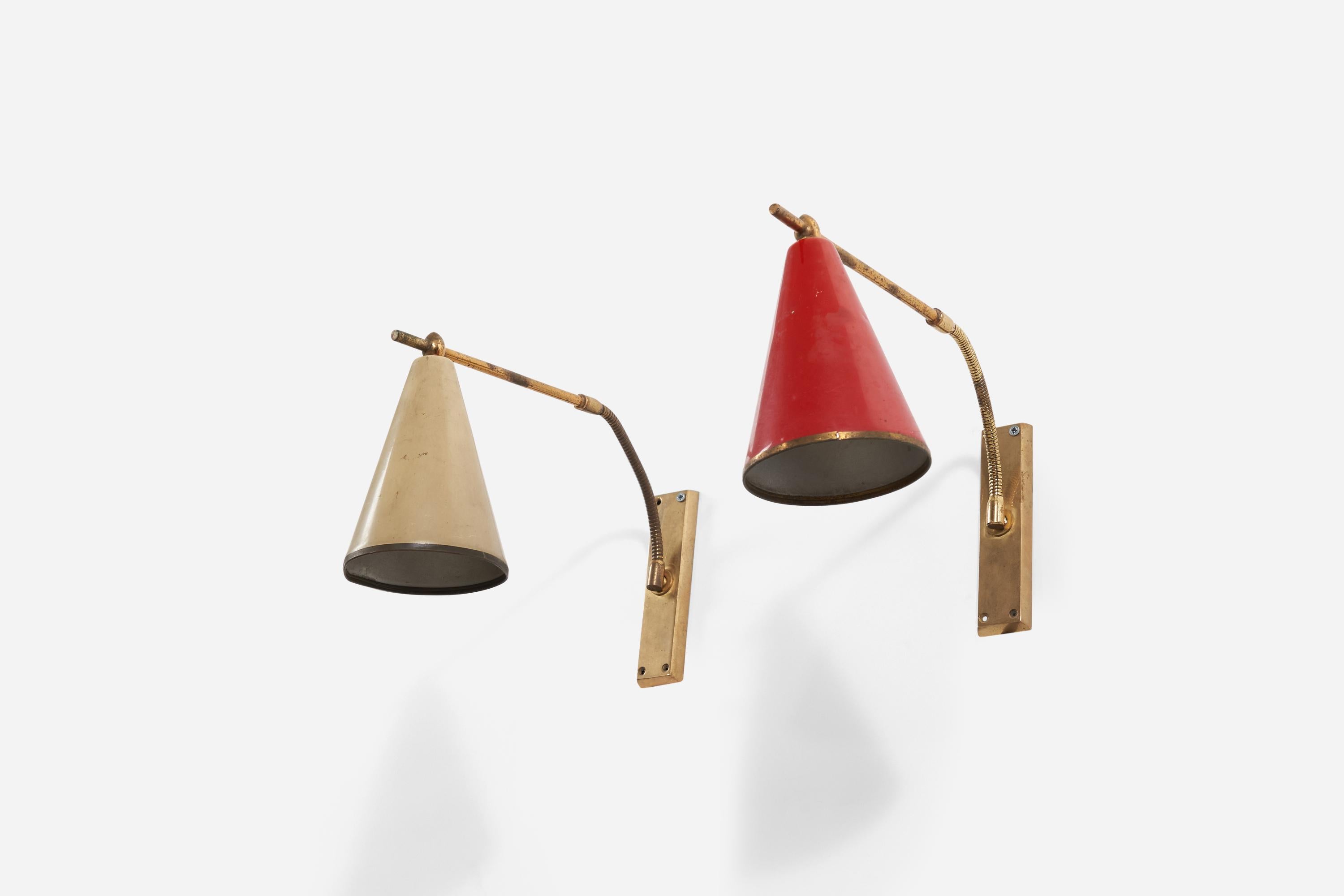 A pair of adjustable brass wall lights with beige and red lacquered shades, designed and produced in Italy, 1950s.