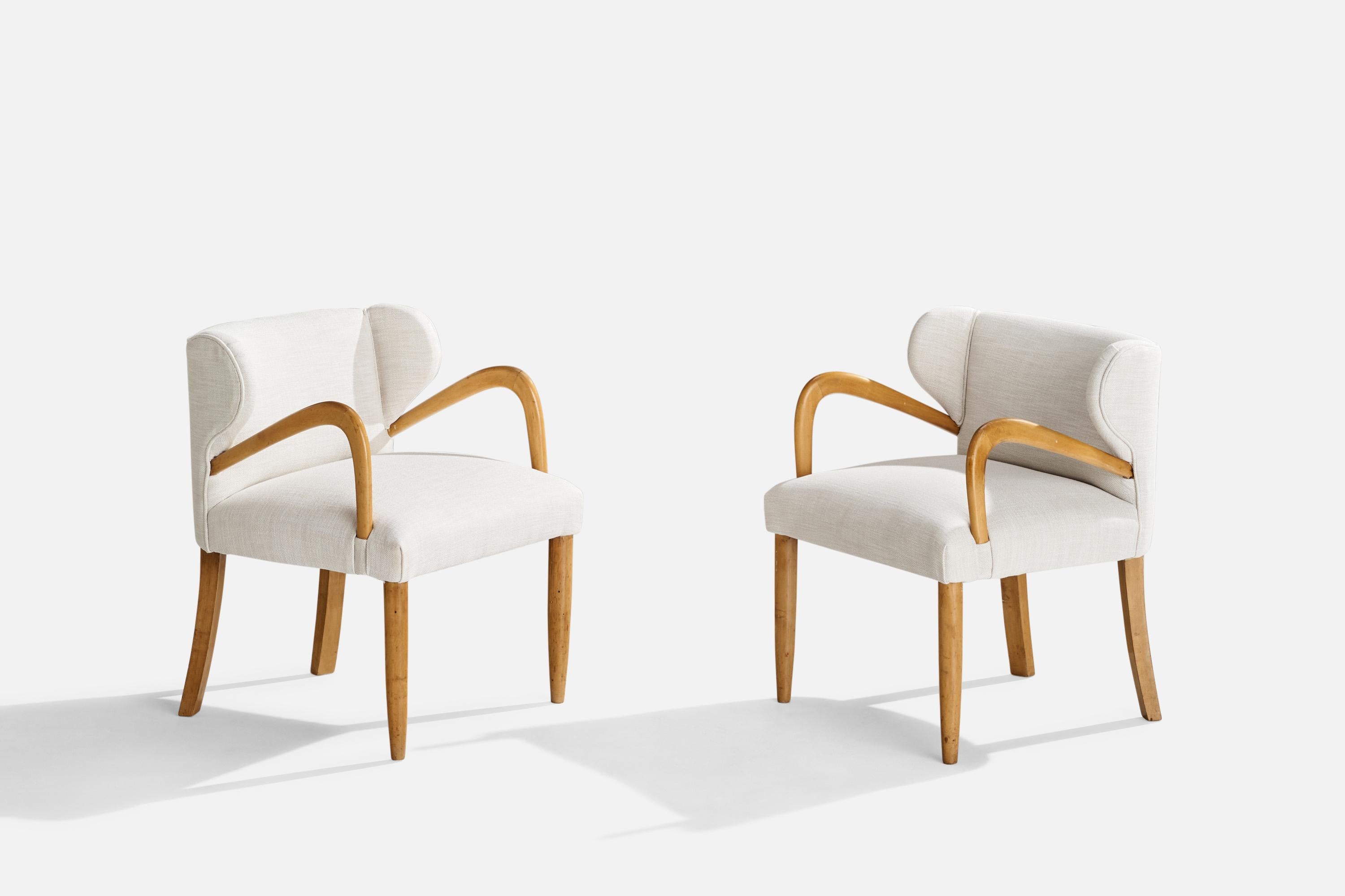 A pair of wood and white fabric armchairs designed and produced in Italy, c. 1940s.

Seat height: 16”
