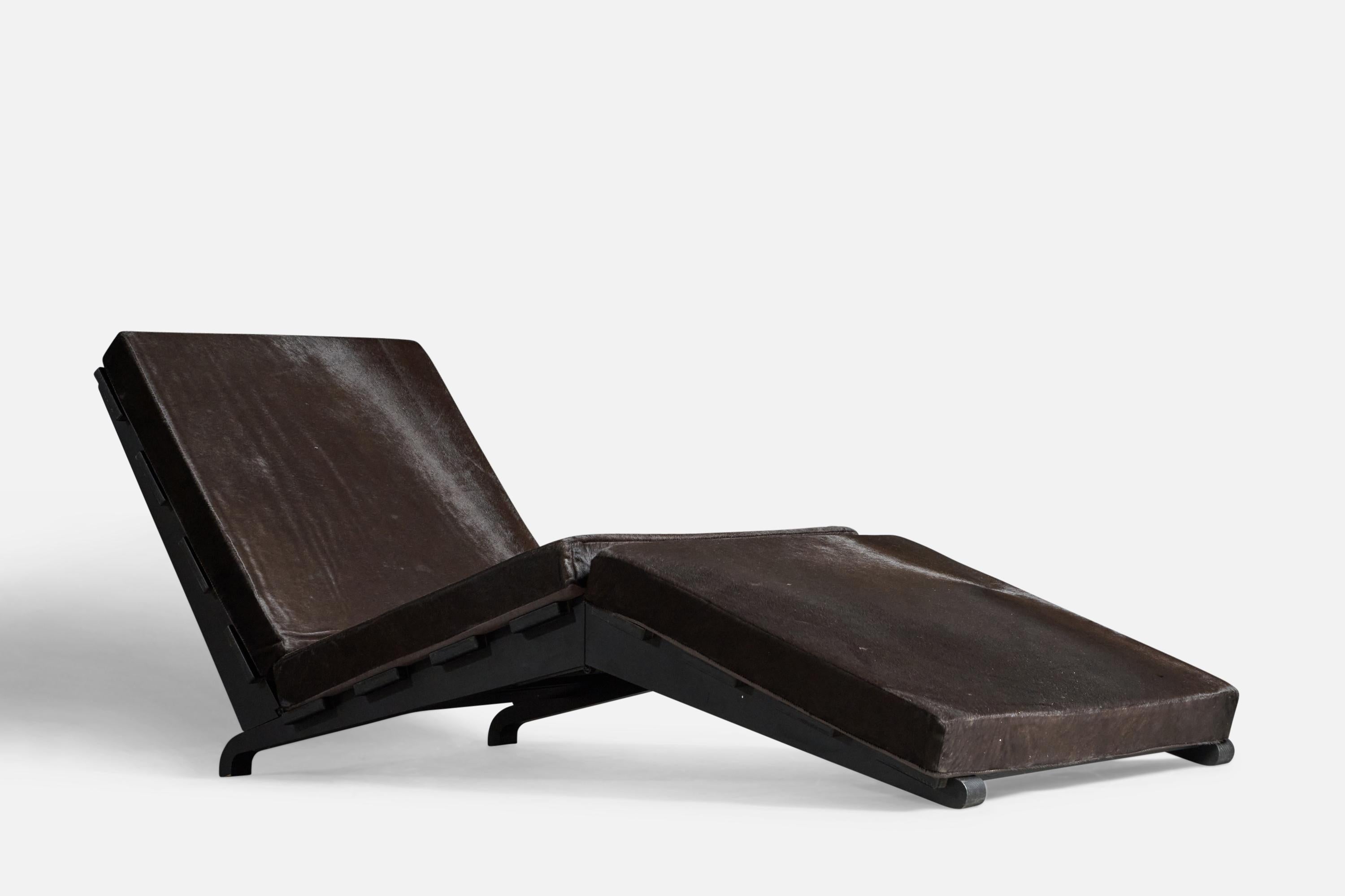 A foldable black painted wood and black cow hide chaise longue, designed and produced in Italy, c. 1980s.