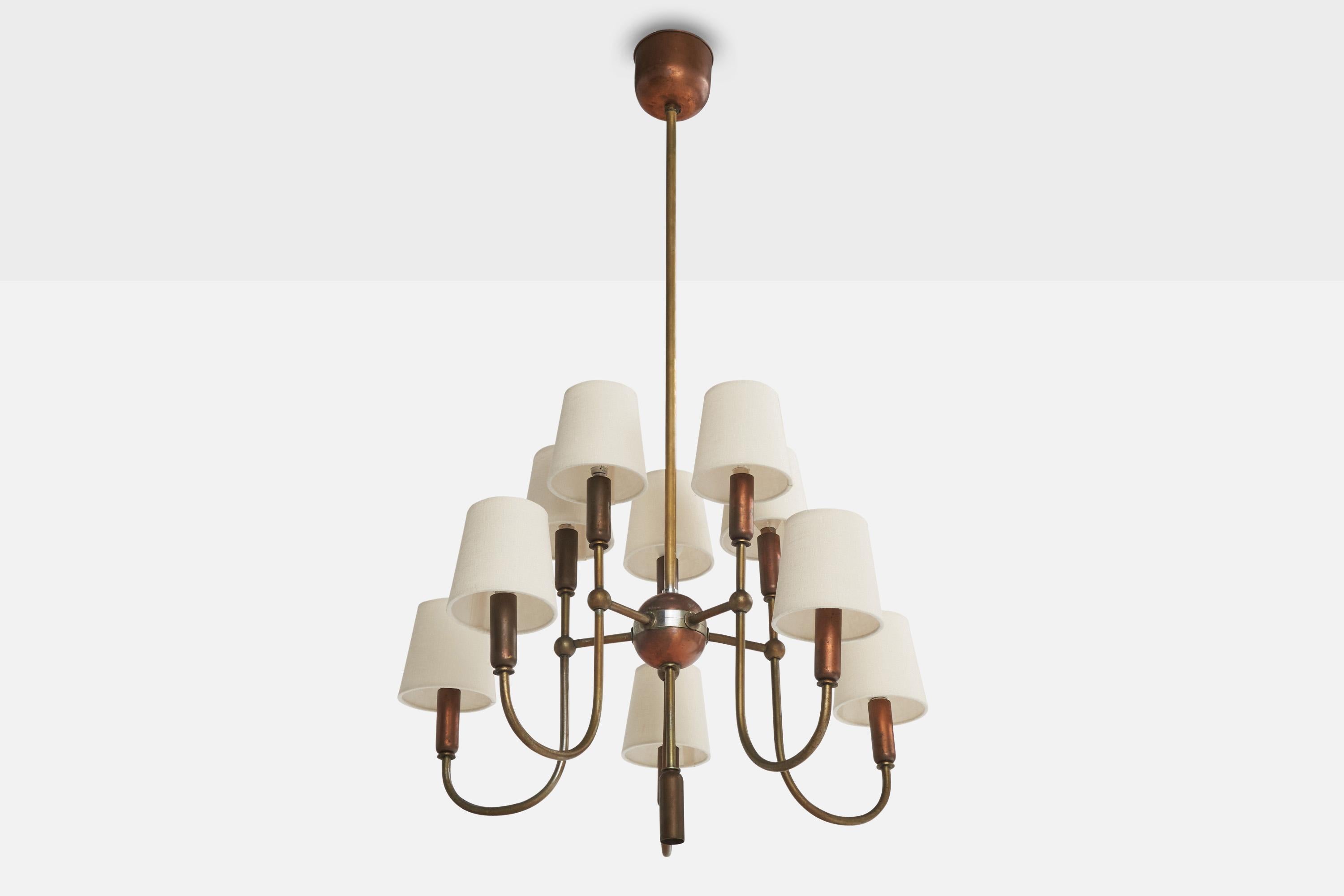 A brass, copper and white fabric chandelier designed and produced in Italy, c. 1950s.

Please note the one socket pointing downwards not utilized in illustrated configuration.

Overall Dimensions (inches): 39” H x  25” Diameter

Dimensions of