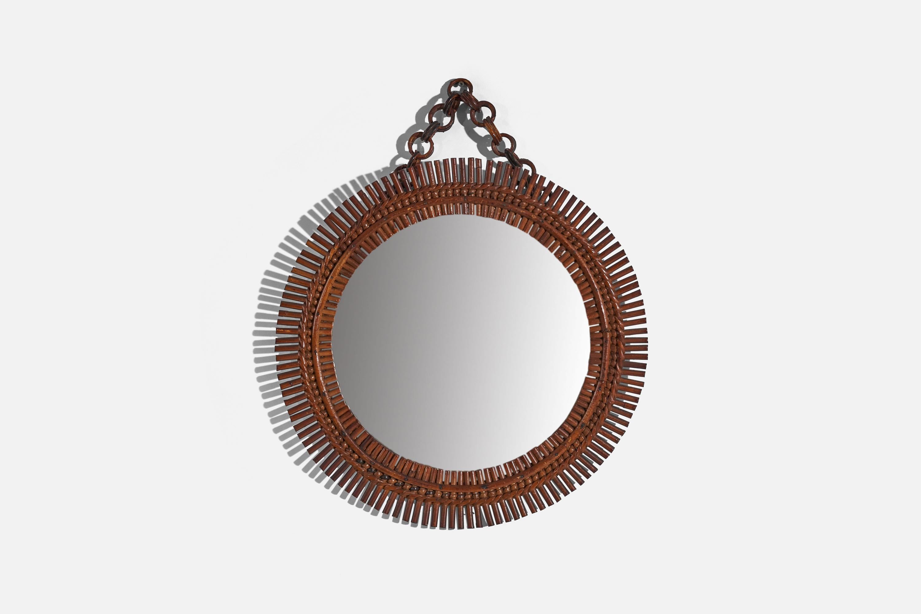 A circular, rattan wall mirror designed and produced by an Italian designer, Italy, 1950s-1960s.
 