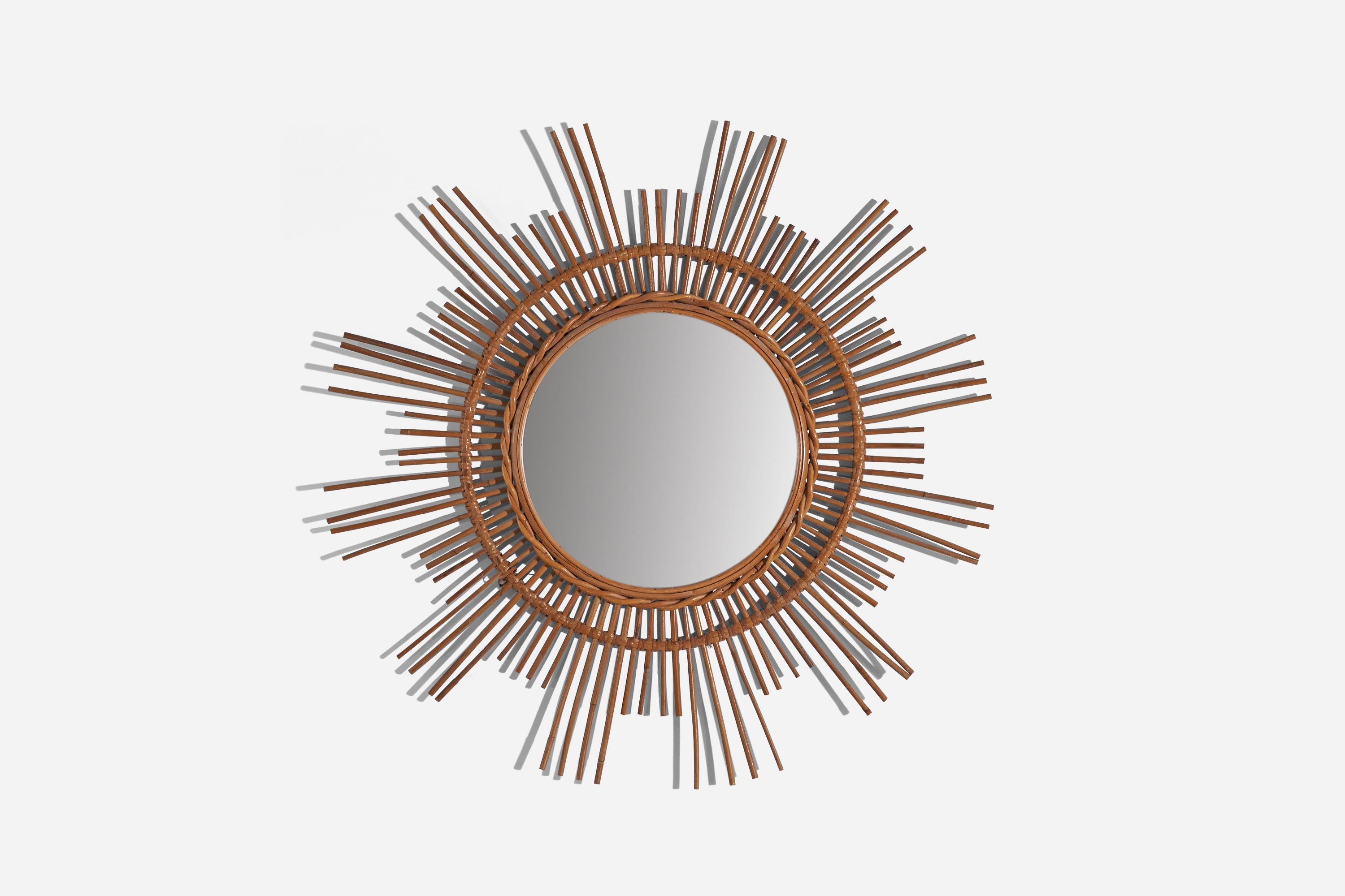 A circular, rattan wall mirror designed and produced by an Italian designer, Italy, 1950s-1960s.
    
