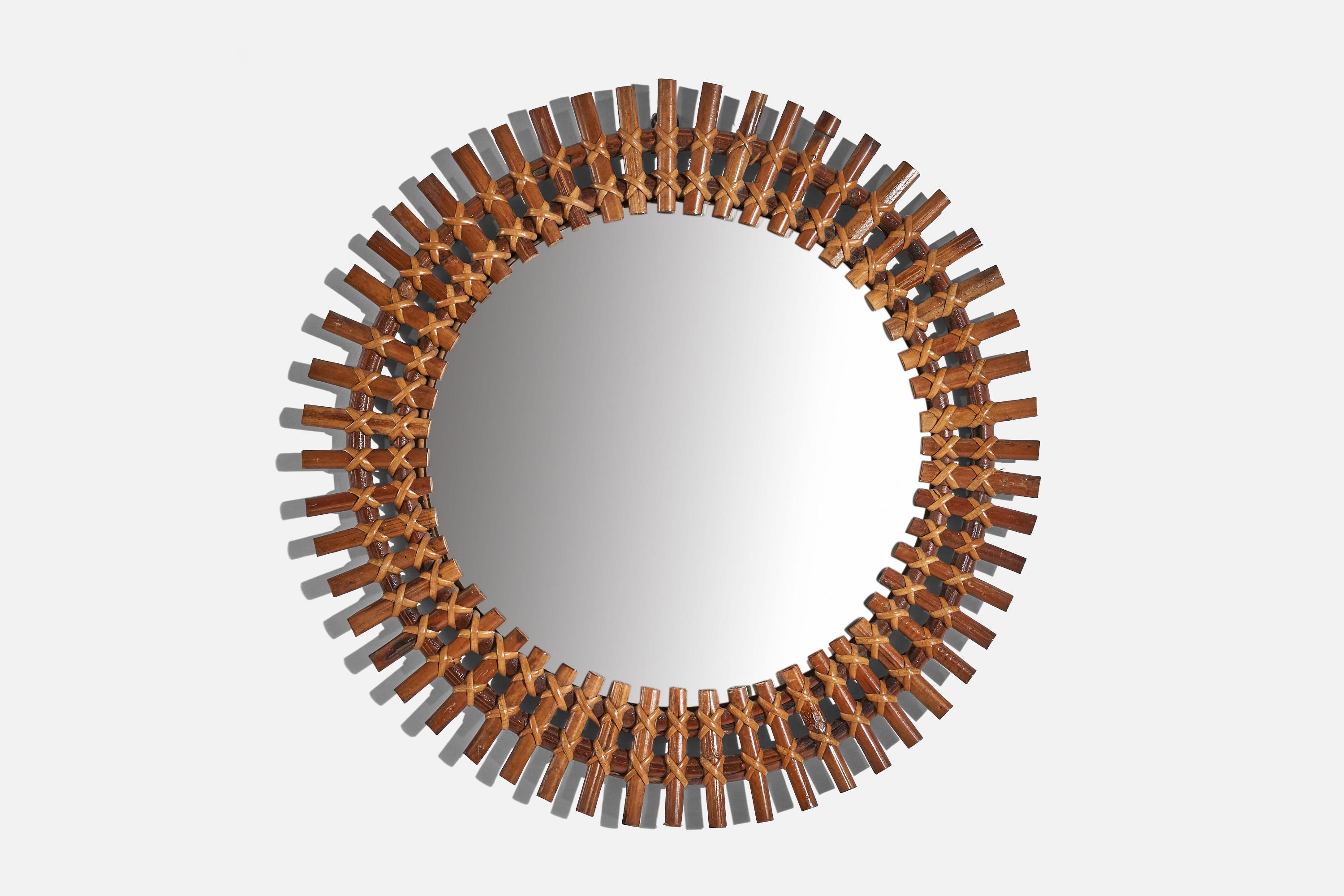 A circular, rattan wall mirror designed and produced by an Italian designer, Italy, 1950s-1960s.
   