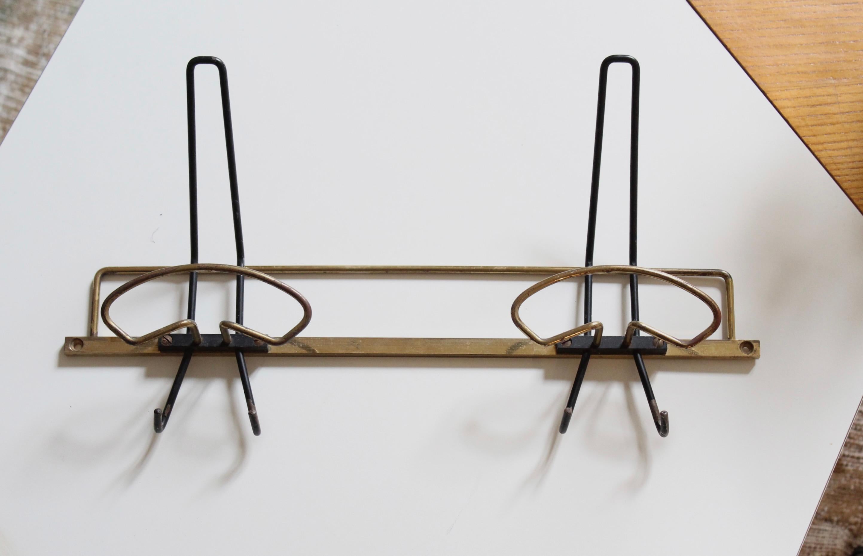 A brass coat hanger designed and produced by an Italian designer, Italy, 1950s.

