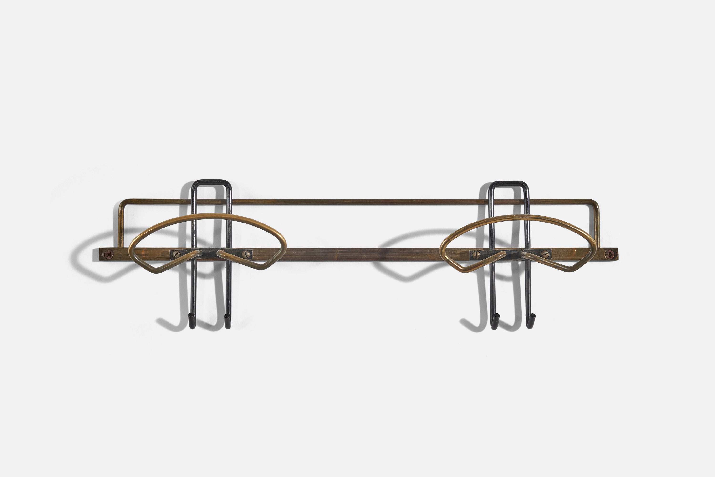 A brass coat hanger designed and produced by an Italian designer, Italy, 1950s.

Dimensions of back plate (inches) : (1.78 x 15.56 x .18).