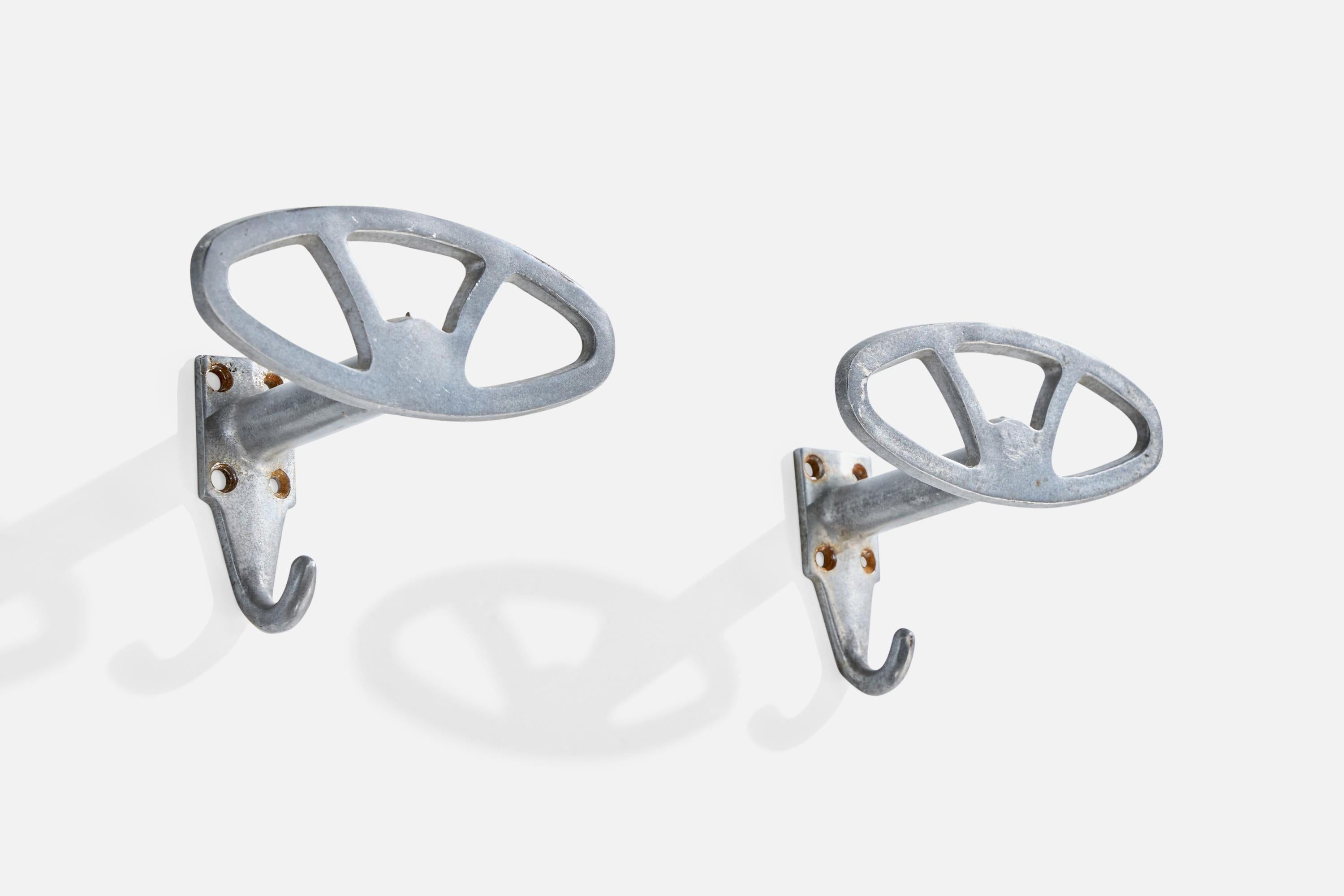 A pair of aluminum coat hangers designed and produced in Italy, c. 1930s.

Oxidation present to aluminum

Wear consistent with age and use

Overall Dimensions (inches): 4.0