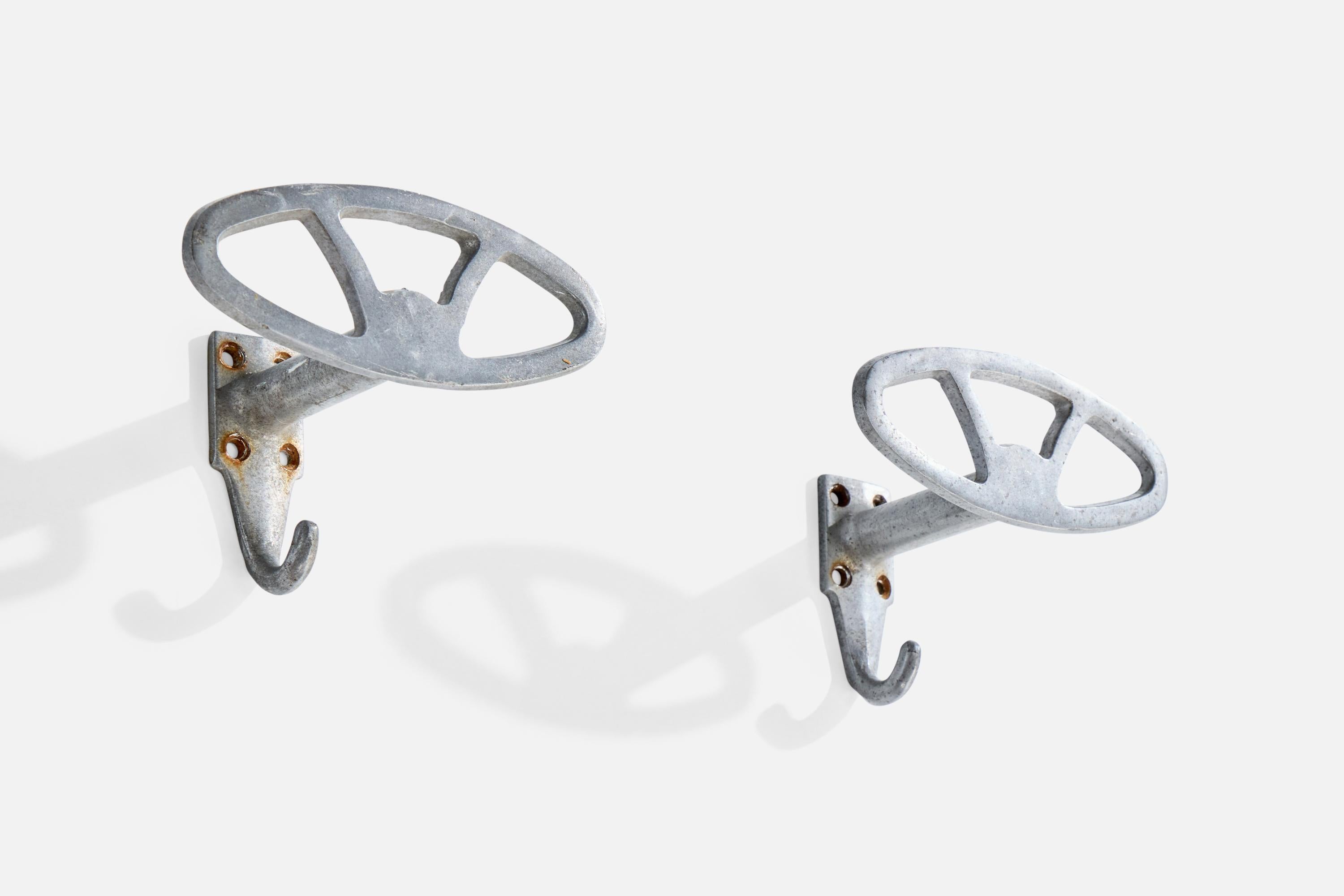 A pair of aluminum coat hangers designed and produced in Italy, c. 1930s.

Oxidation present to aluminum

Wear consistent with age and use

Overall Dimensions (inches): 4.0