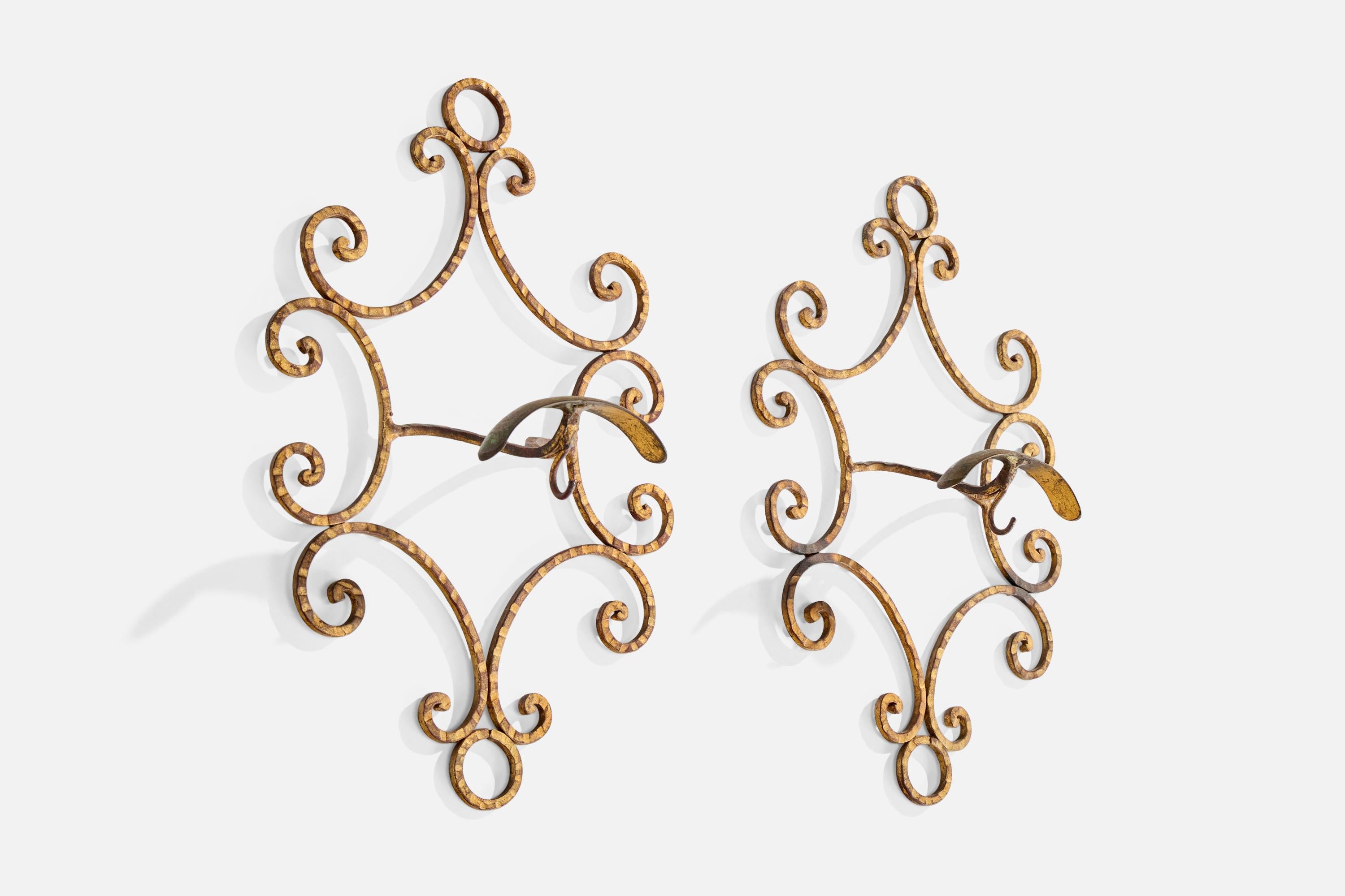 A pair of gold-painted brass coat hangers likely designed and produced in Italy, c. 1930s.

Oxidation present to brass

Wear consistent with age and use

Overall Dimensions (inches): 14.0