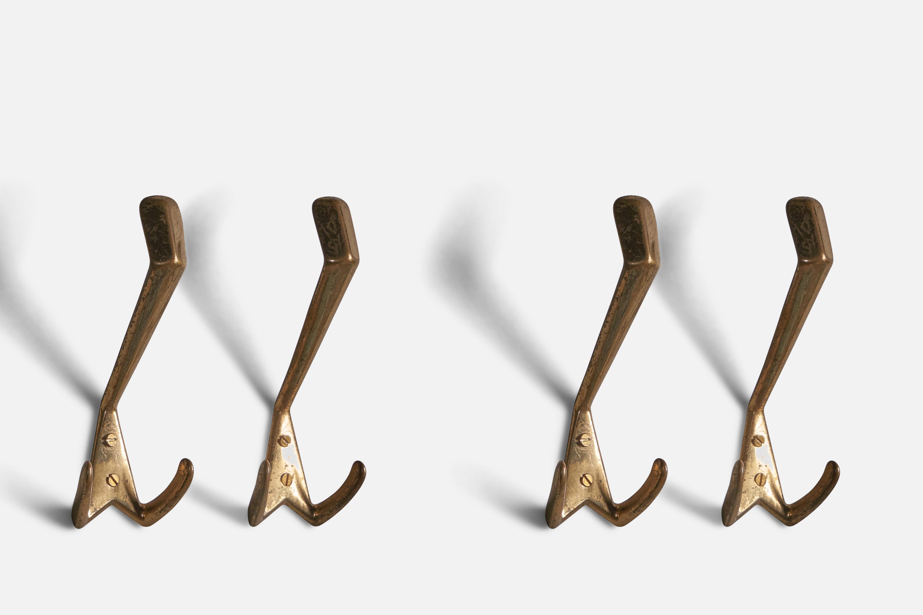 A set of 4 brass coat hangers, designed and produced in Italy, 1940s.
