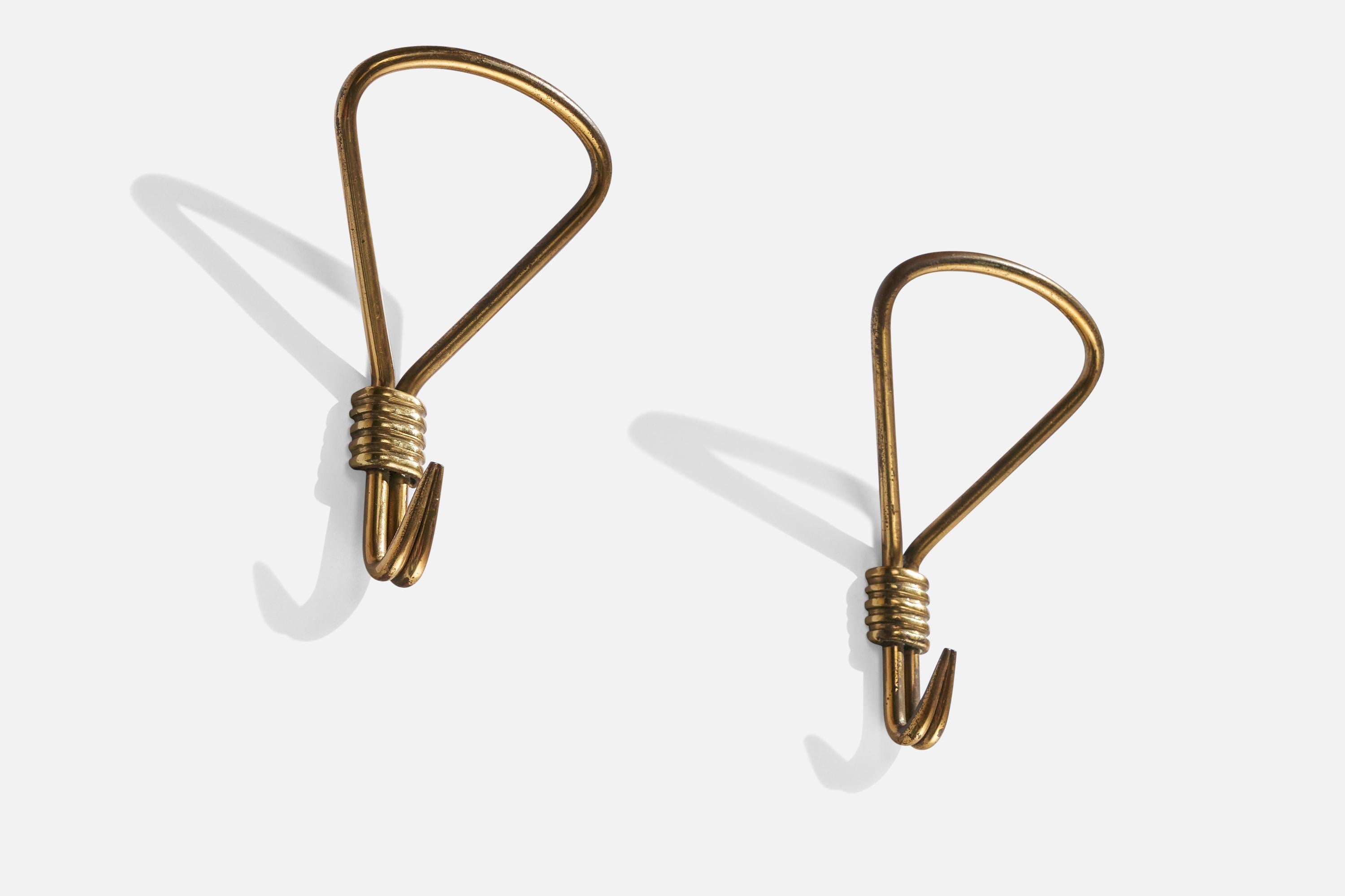 A pair of brass coat hangers designed and produced in Italy, 1940s