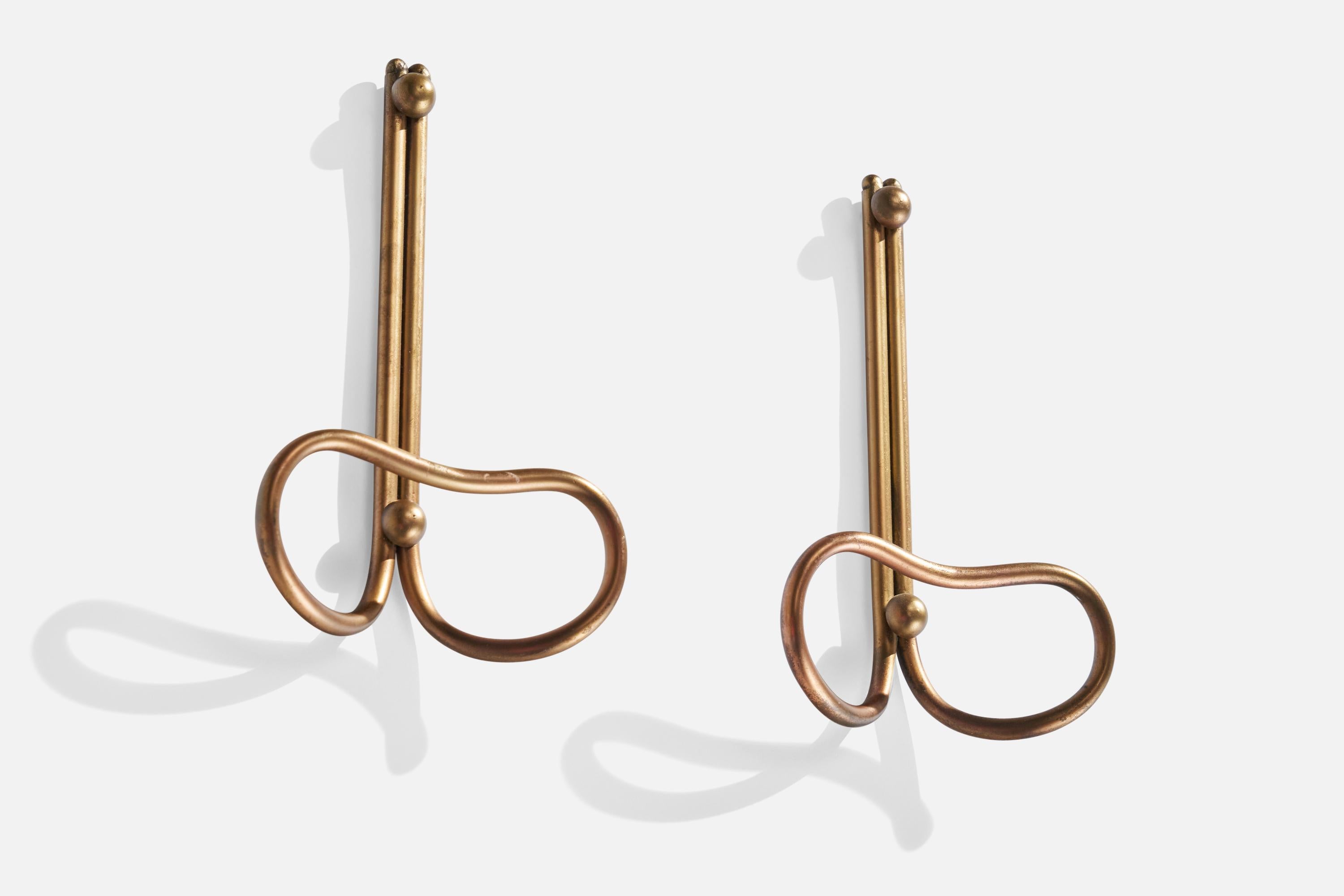 A pair of brass coat hangers designed and produced in Italy, 1940s