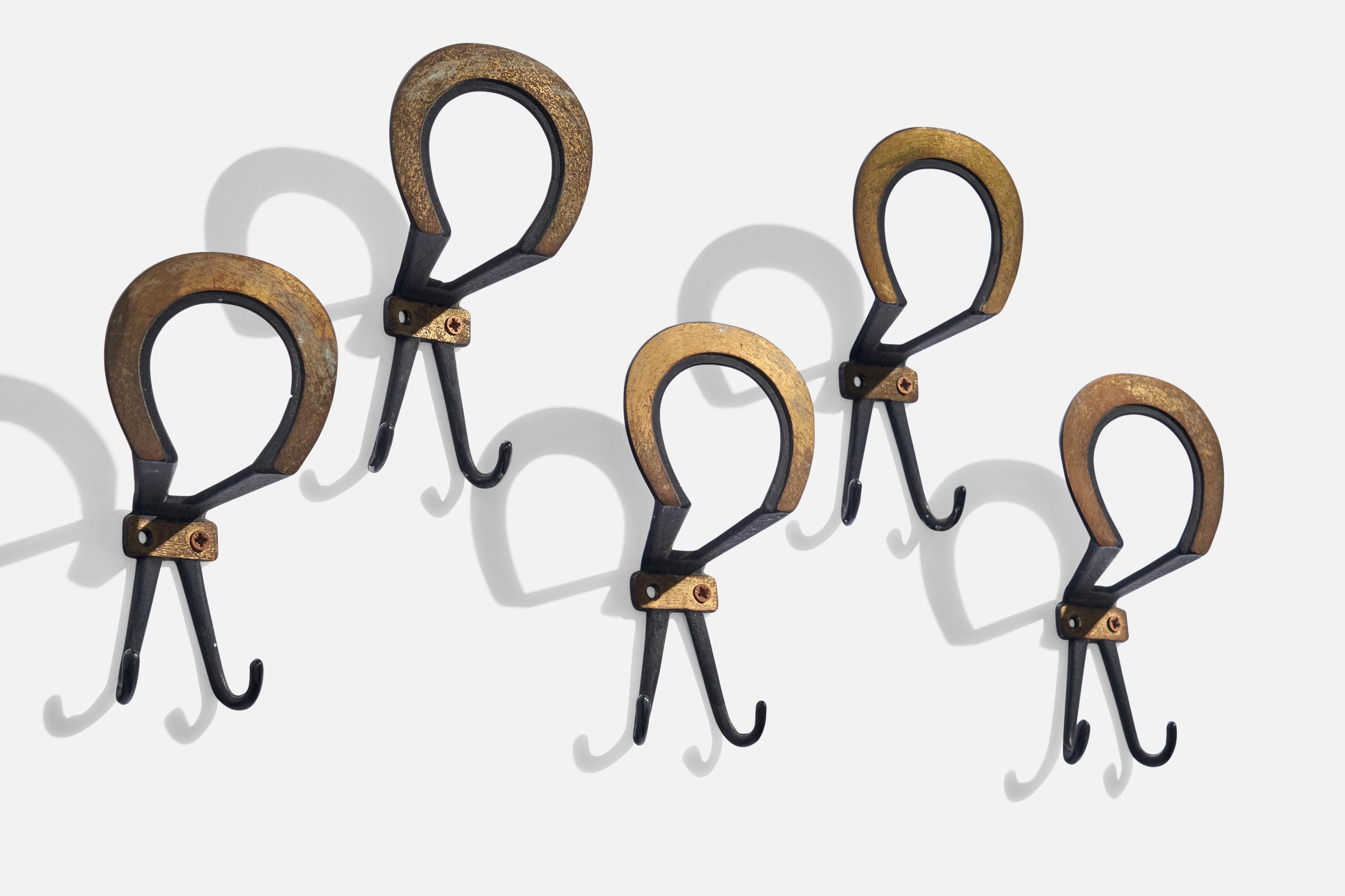 A set of 5 brass and black-lacquered metal coat hangers designed and produced in Italy, c. 1930s.

