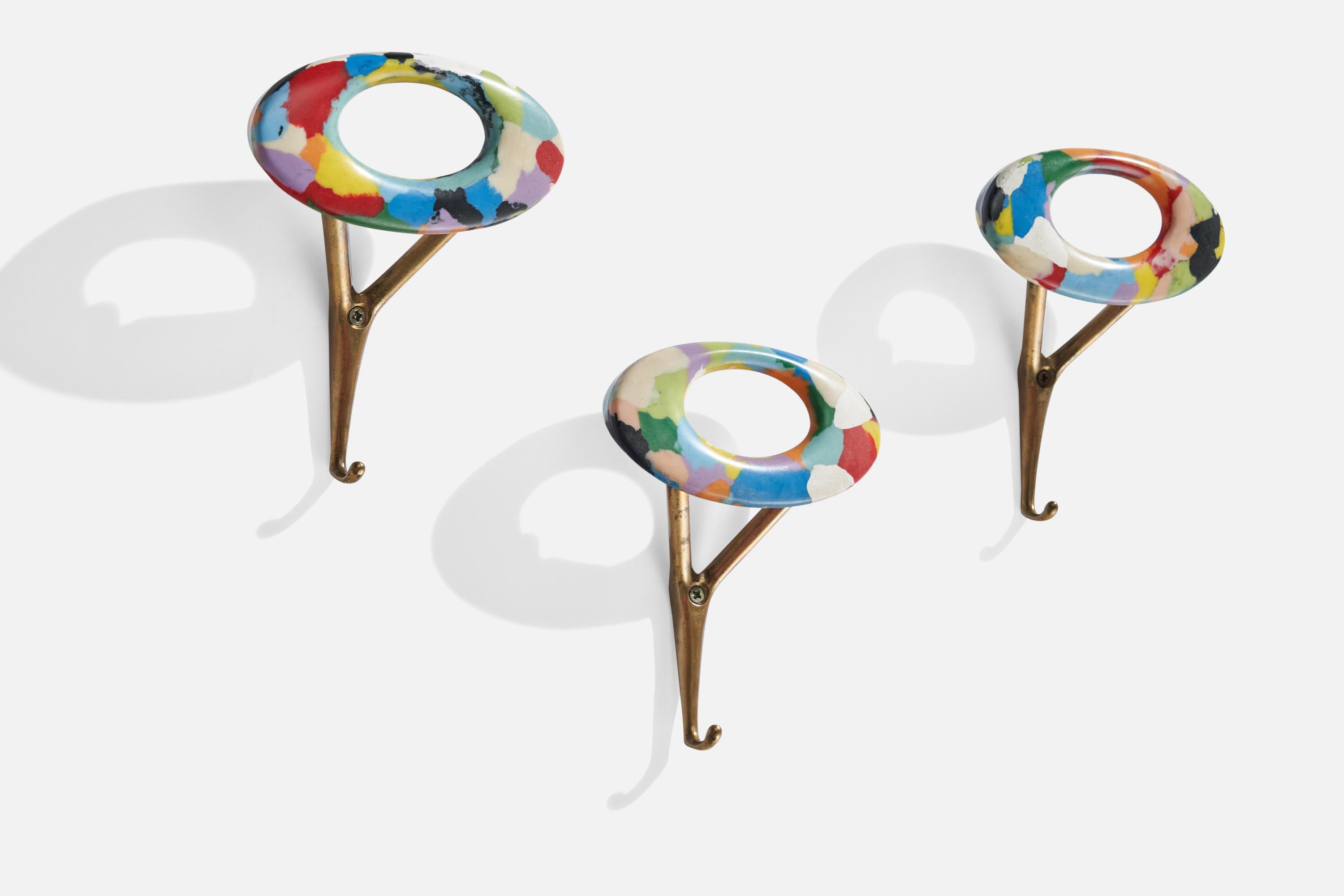A set of 3 brass and multi-colored resin coat hangers designed and produced in Italy, 1950s.
