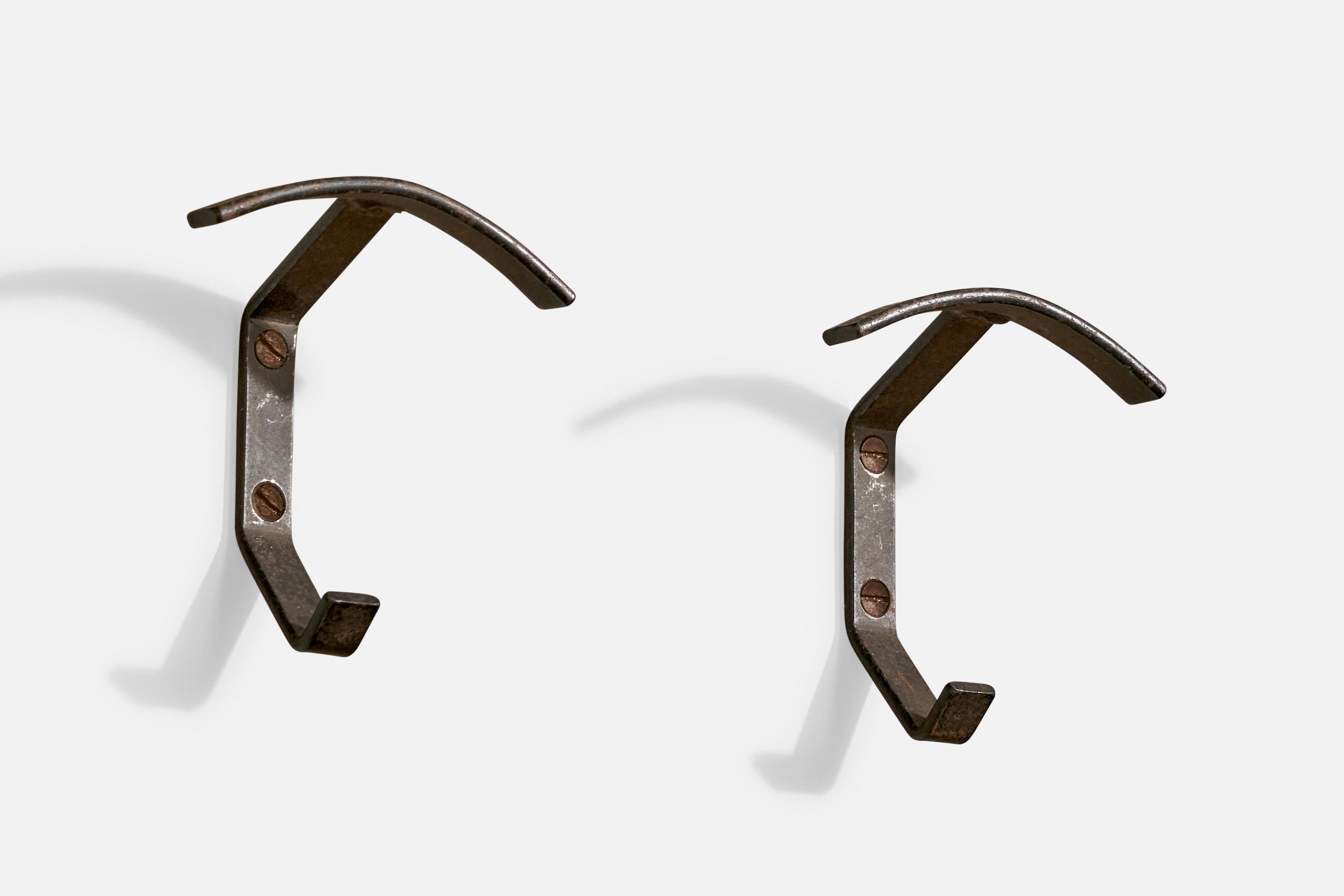 A pair of iron coat hangers designed and produced in Italy, c. 1940s.

*some discoloration 