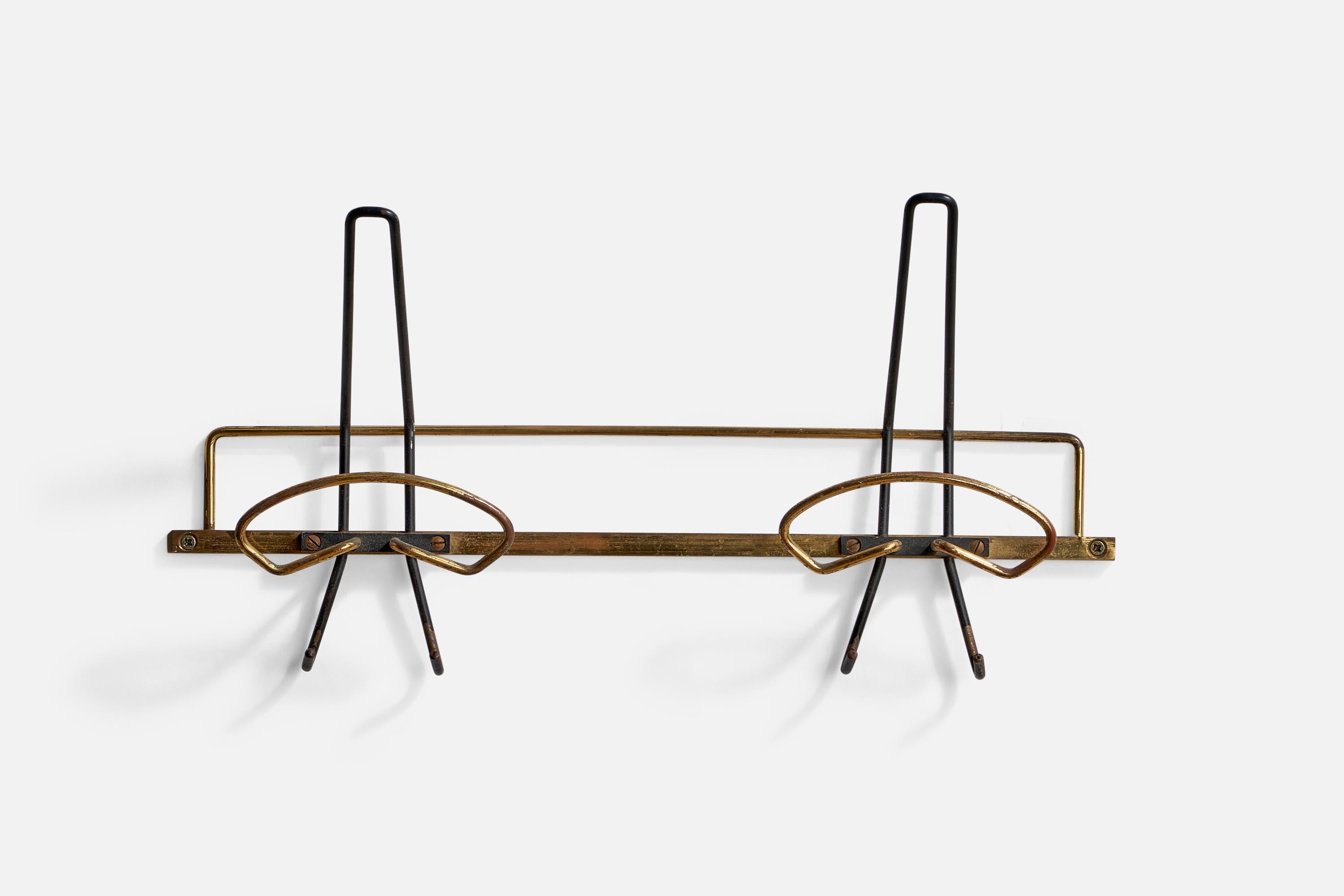 A brass and black-lacquered metal coat rack designed and produced in Italy, 1950s.