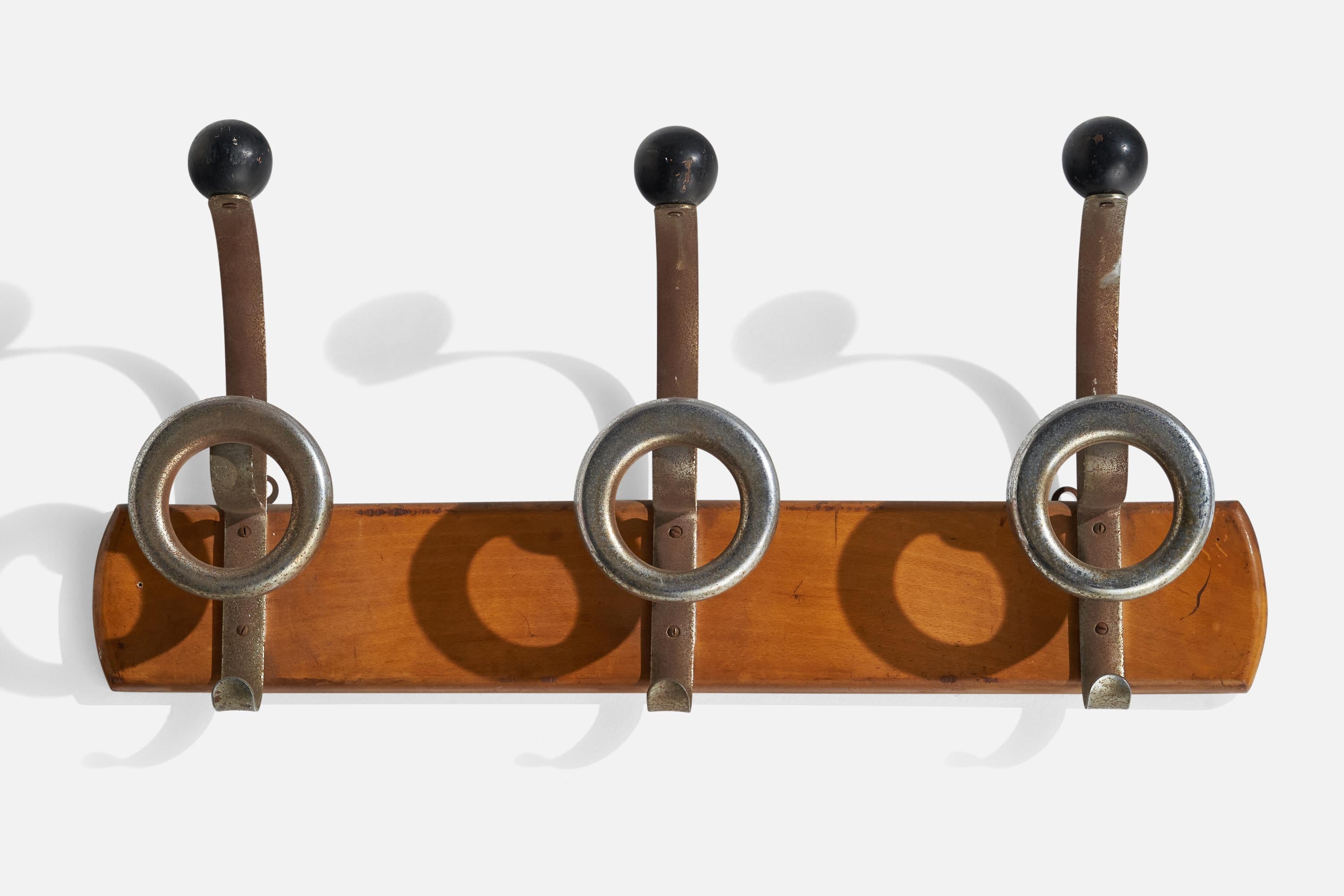 A wood, aluminium and bakelite coat rack designed and produced in Italy, 1930s.