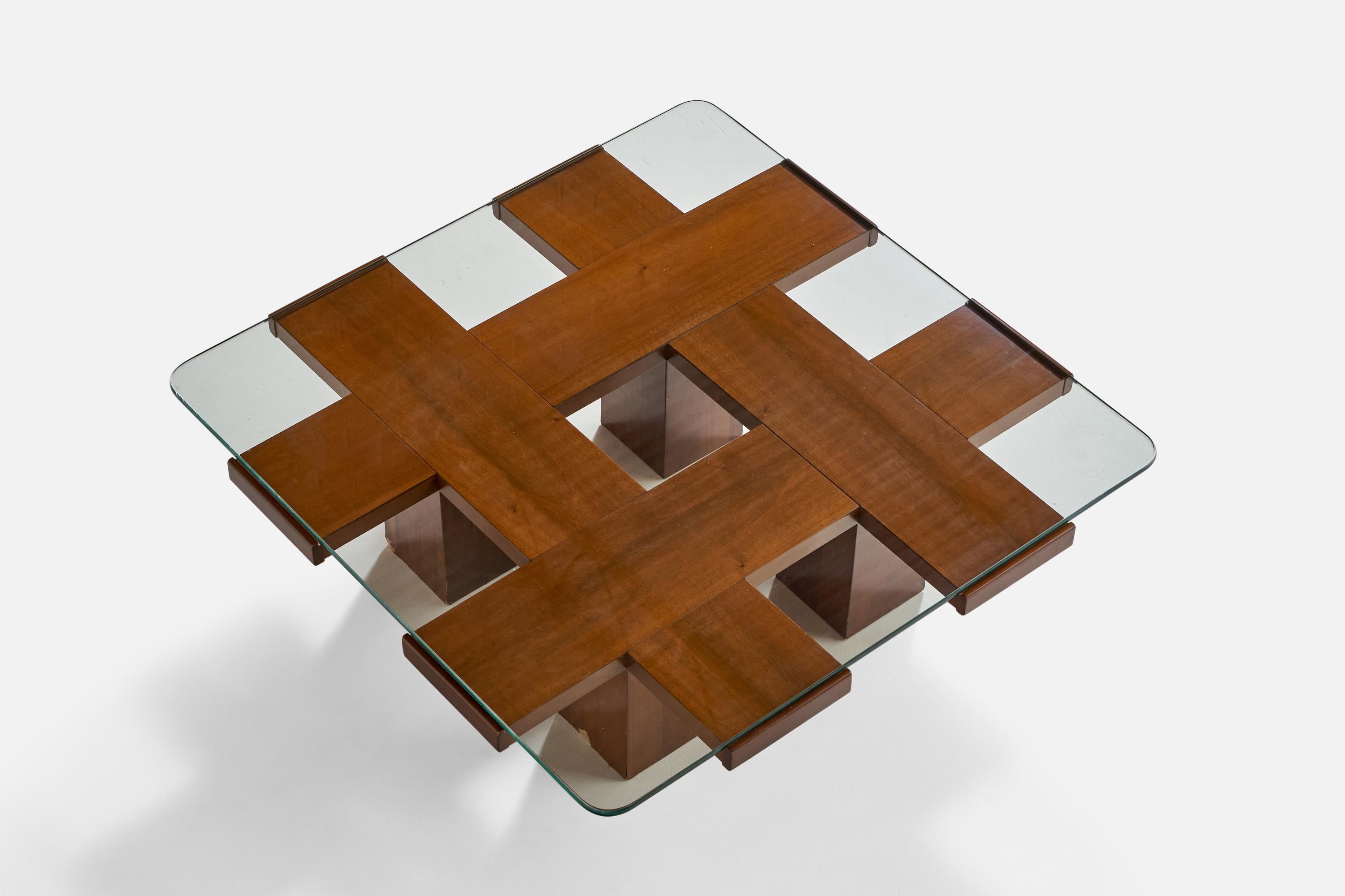 A walnut and glass coffee table designed and produced in Italy, 1950s.