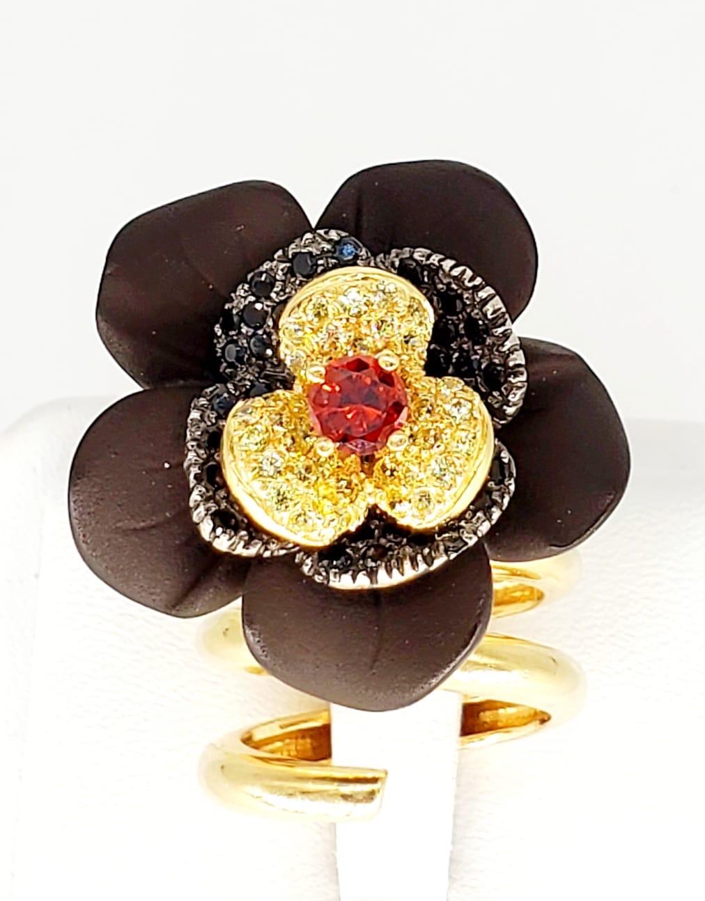 Italian Designer Custom Made Flower Cluster Cocktail Ring. A ring unlike no other, very special piece. To get started there are mixed coloured stones including green, yellow, red and black around the flower that actually can be tilted from side to