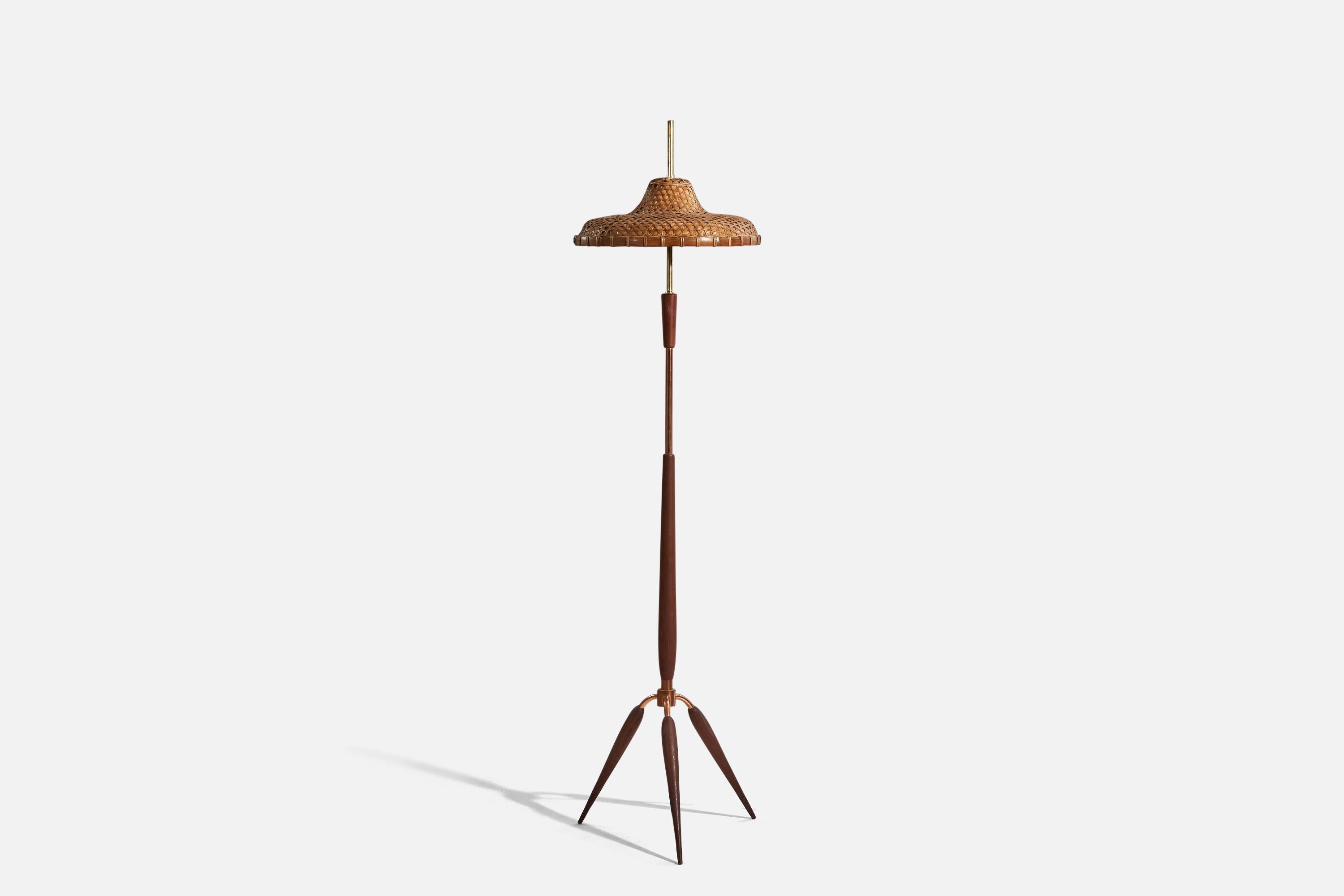 A brass, copper, teak and rattan floor lamp designed and produced in Italy, c. 1950s.

Sold with Lampshade. 
Stated dimensions refer to the lamp with the lampshade.
 