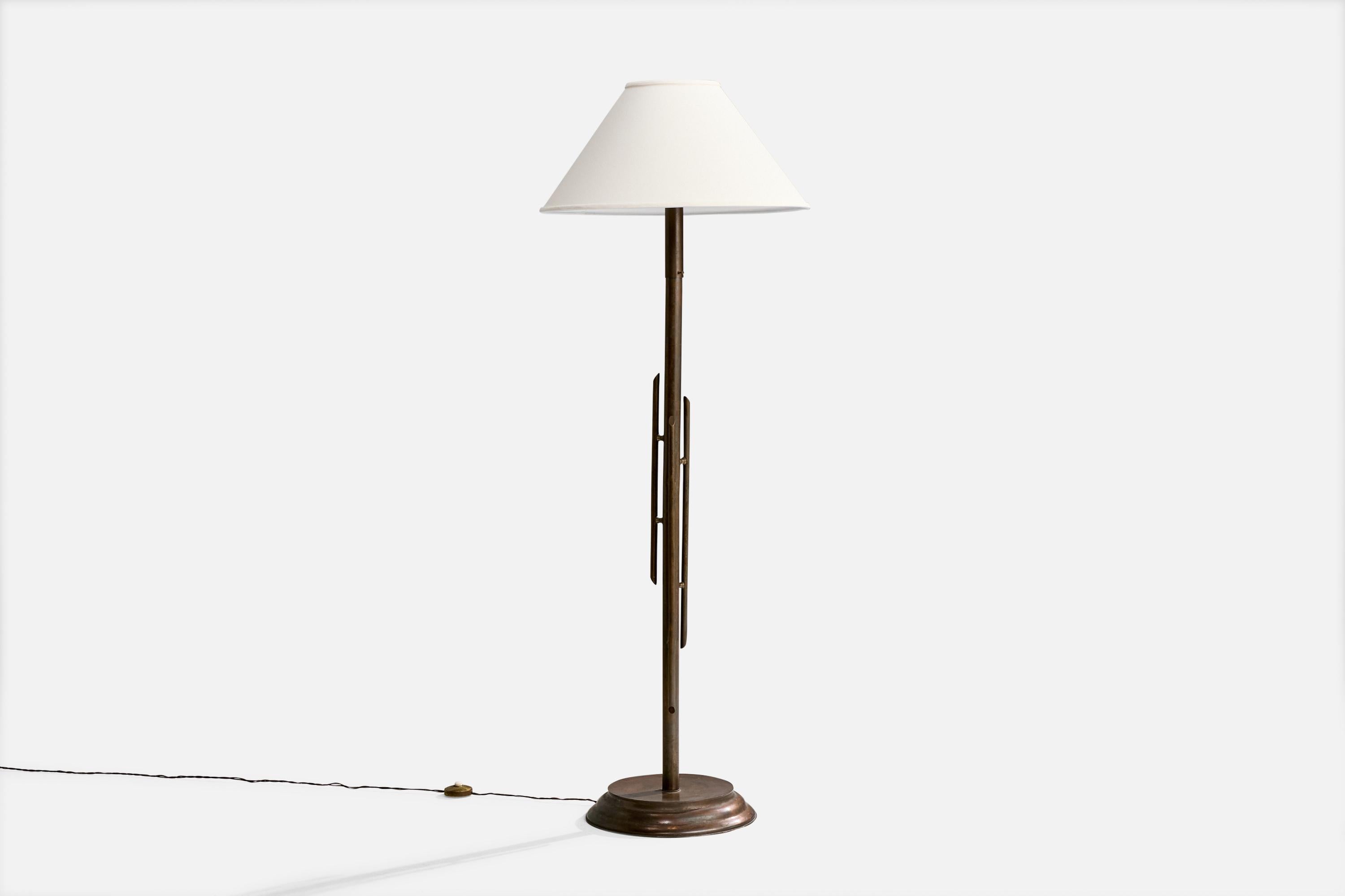 A sizable patinated brass and white fabric floor lamp designed and produced in Italy, c. 1940s.

Dimensions of Lamp with Shade (inches): 67.0