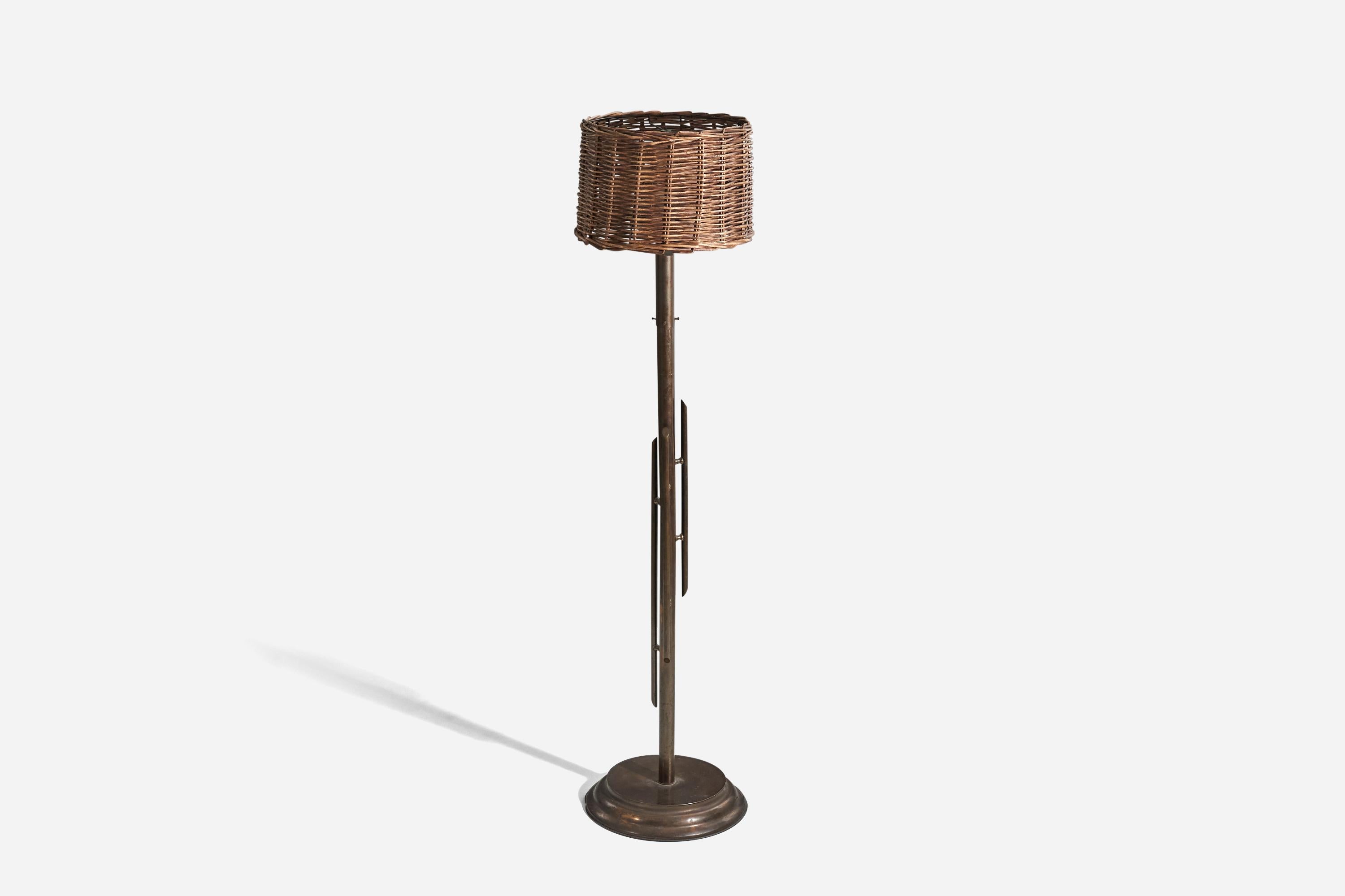 A brass and rattan floor lamp designed and produced in Italy, 1940s.

Sold with lampshade. 
Dimensions stated refers to the floor lamp with shade.