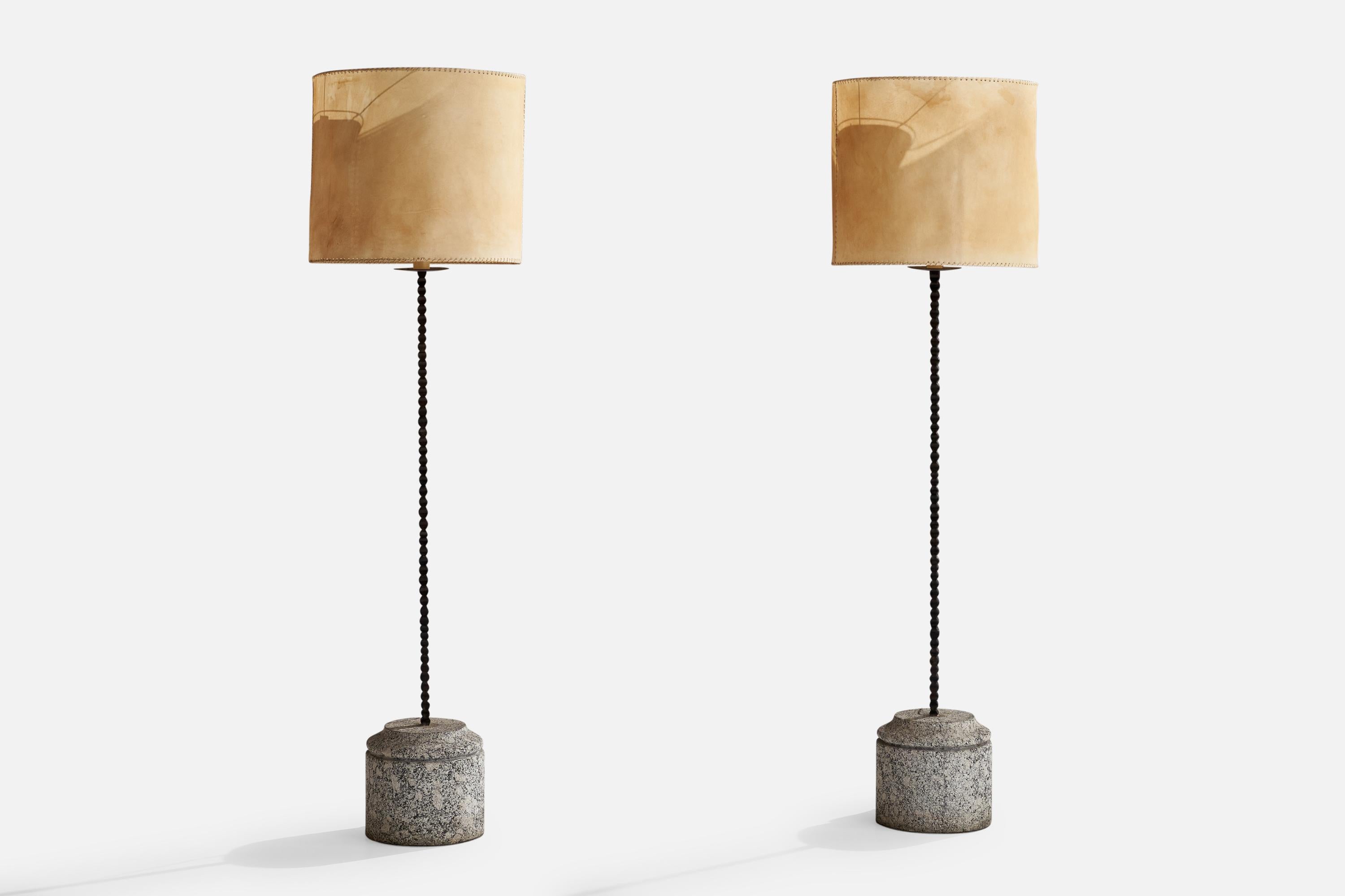 A pair of black-painted iron, granite and goat parchment floor lamps, custom-designed and produced for a private apartment in Milan, Italy, 1950s.

Overall Dimensions (inches): 71” H x 20” W x 9” D
Stated dimensions include shade.
Bulb
