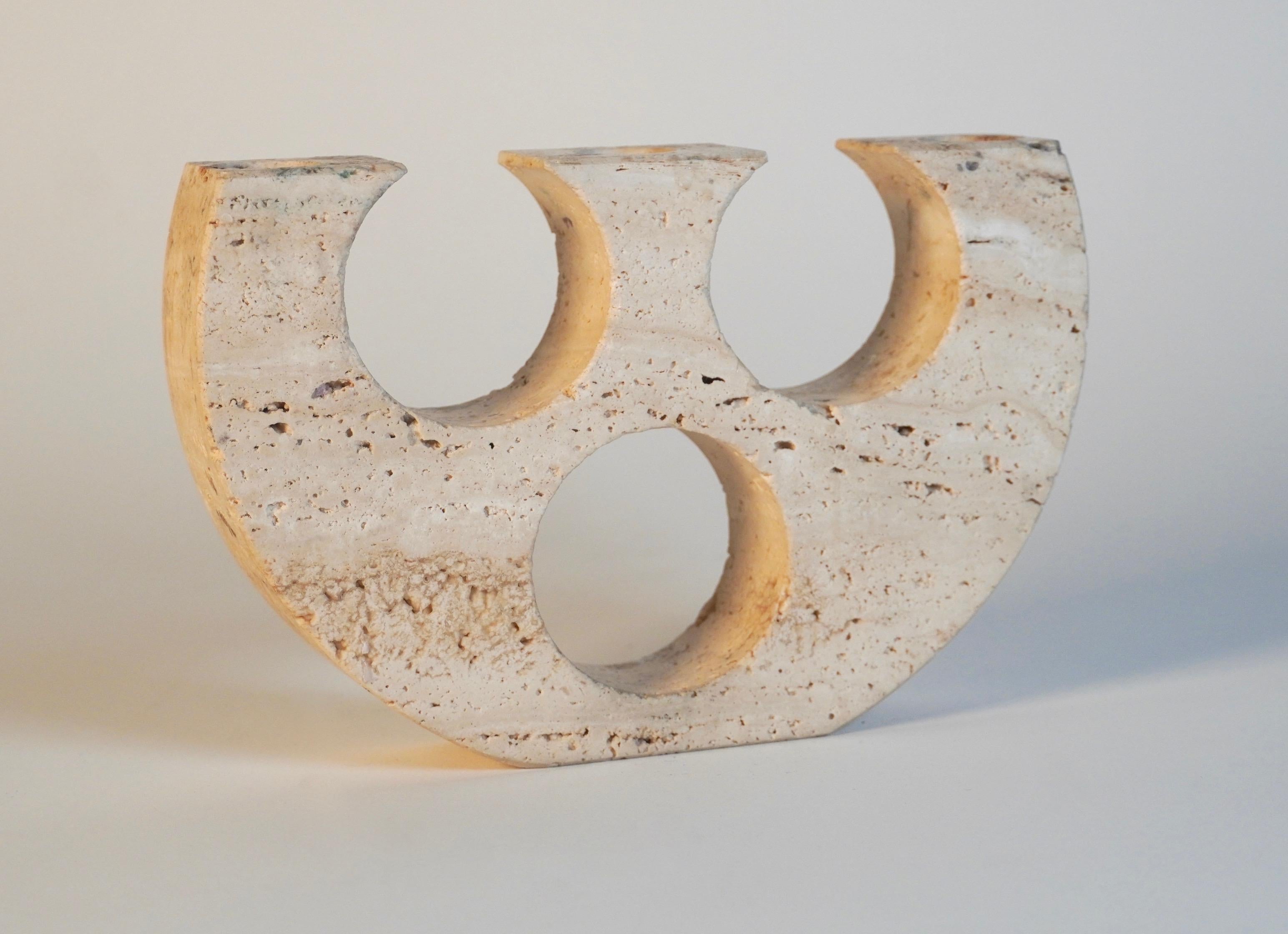 Travertine candle hold by Italian designer Fratelli Mannelli, a 3 candle holder carved in a soft half circle form with circular cutouts.
