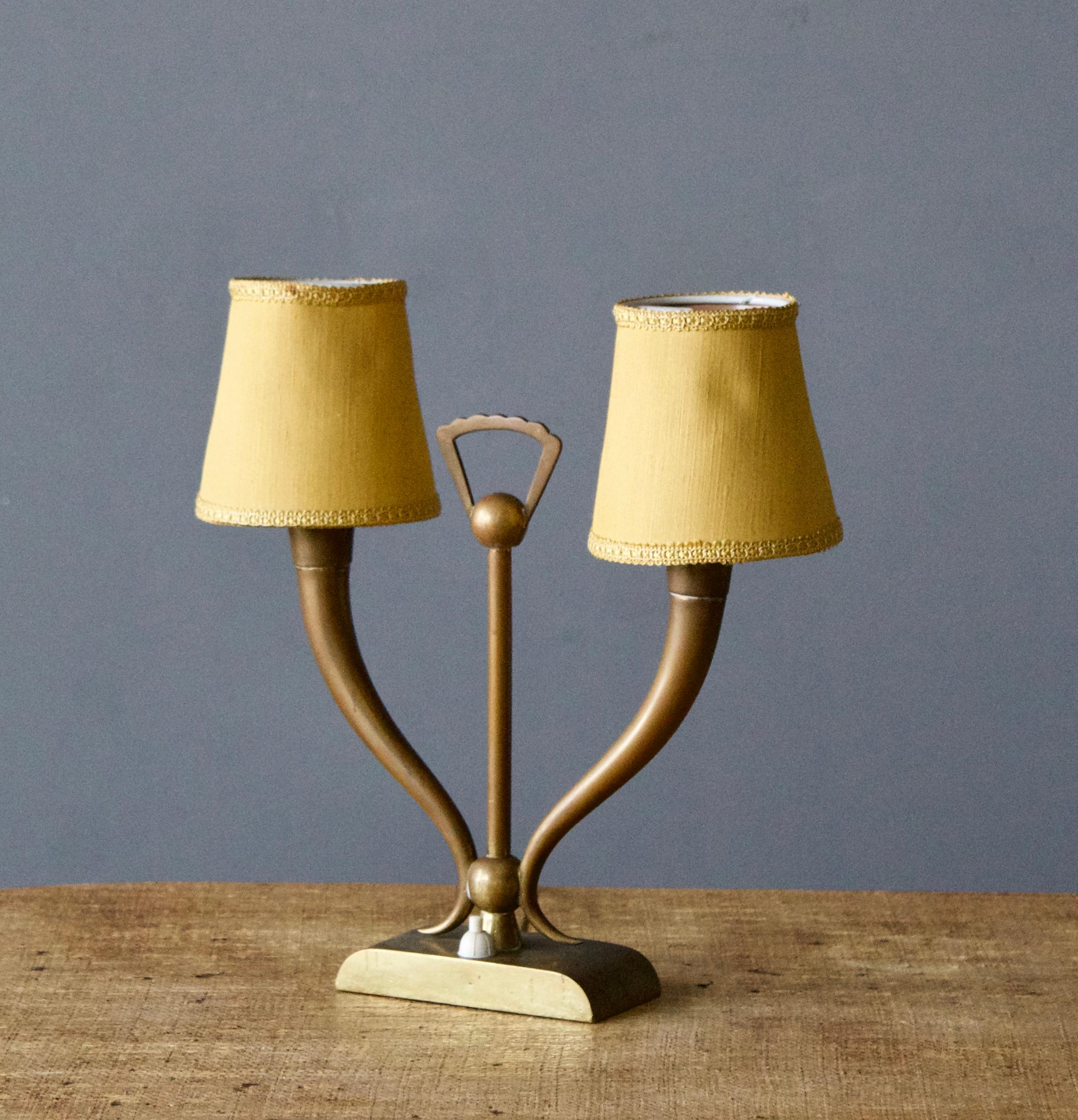 A table lamp, produced in Italy, 1960s. Brass, green acrylic and original fabric lampshade. Stamped 