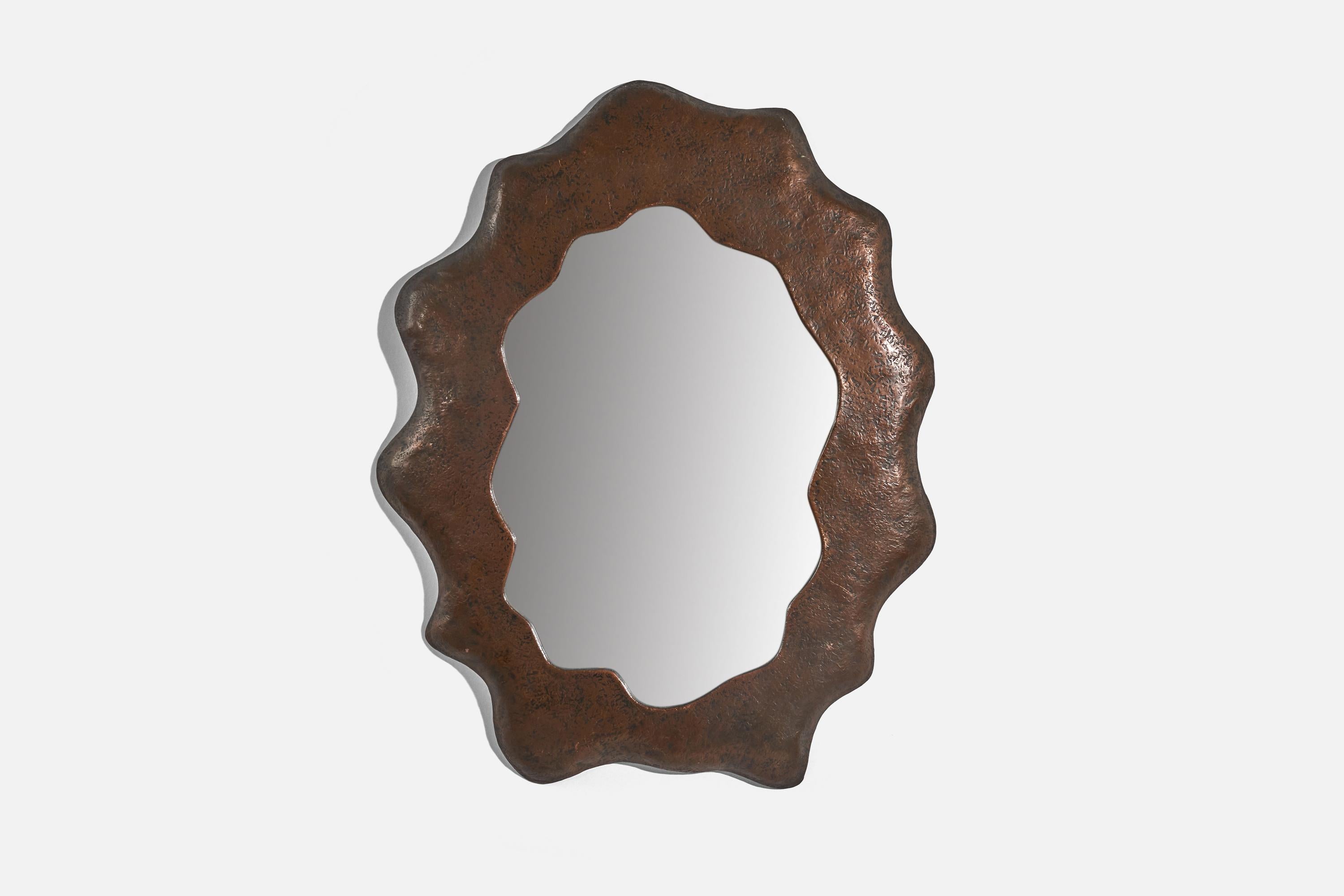 A copper wall mirror designed and produced in Italy, c. 1950s.
 
