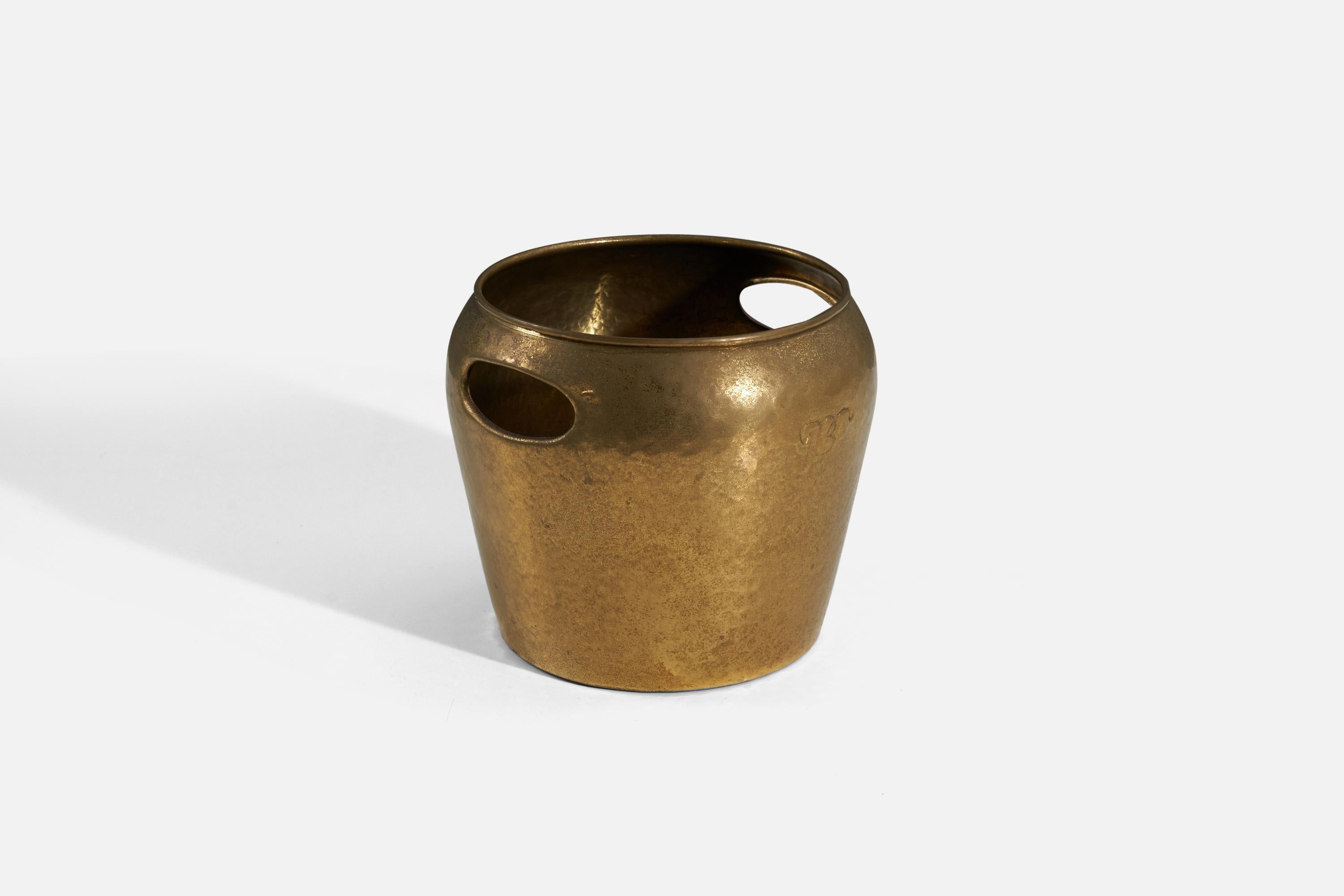 A hammered brass ice bucket designed and produced by an Italian designer, Italy, 1940s.