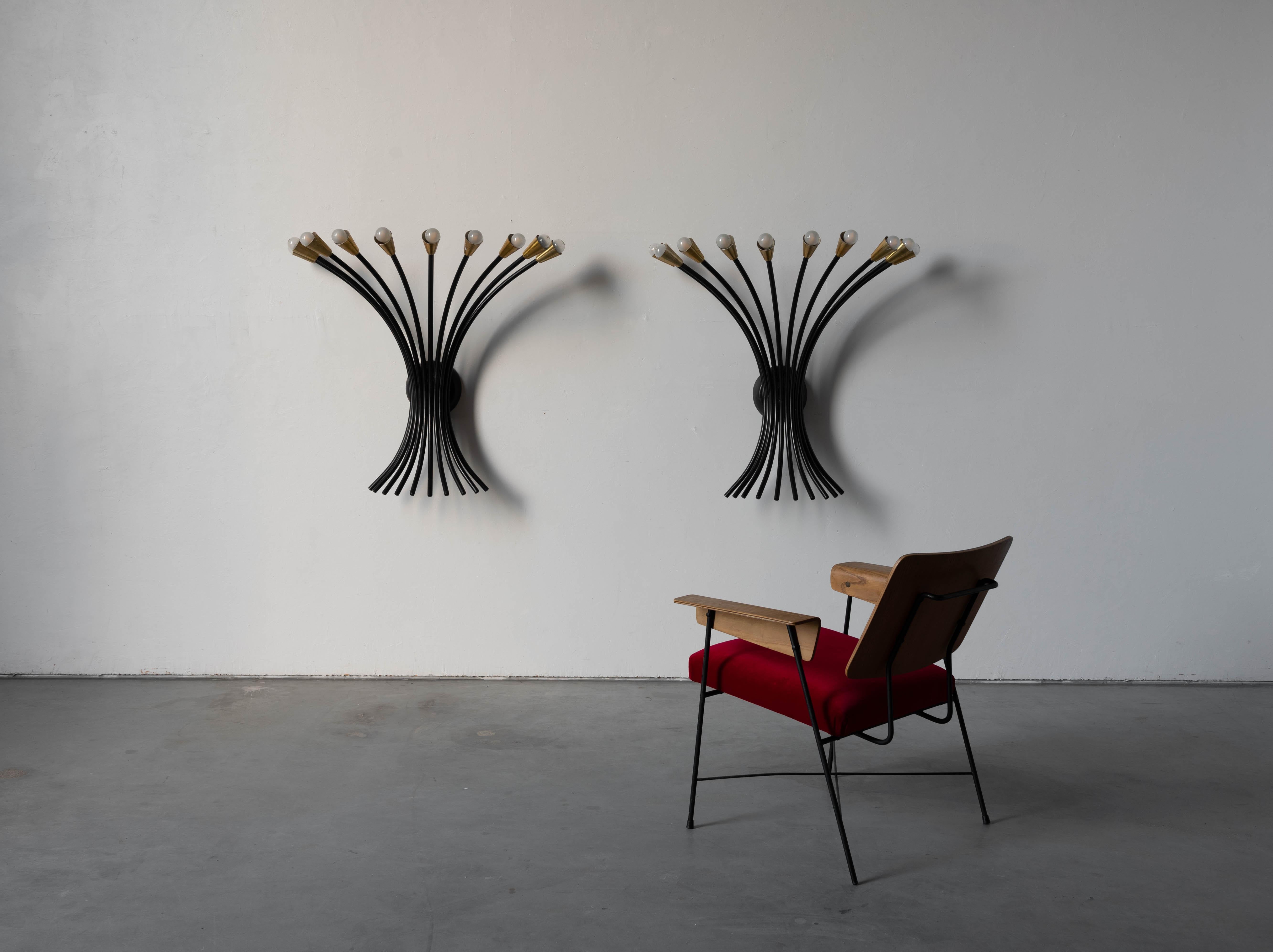 A pair of large and impressive brass and black-lacquered metal sconces/ wall lights designed and produced by an Italian designer, Italy, 1960s.


