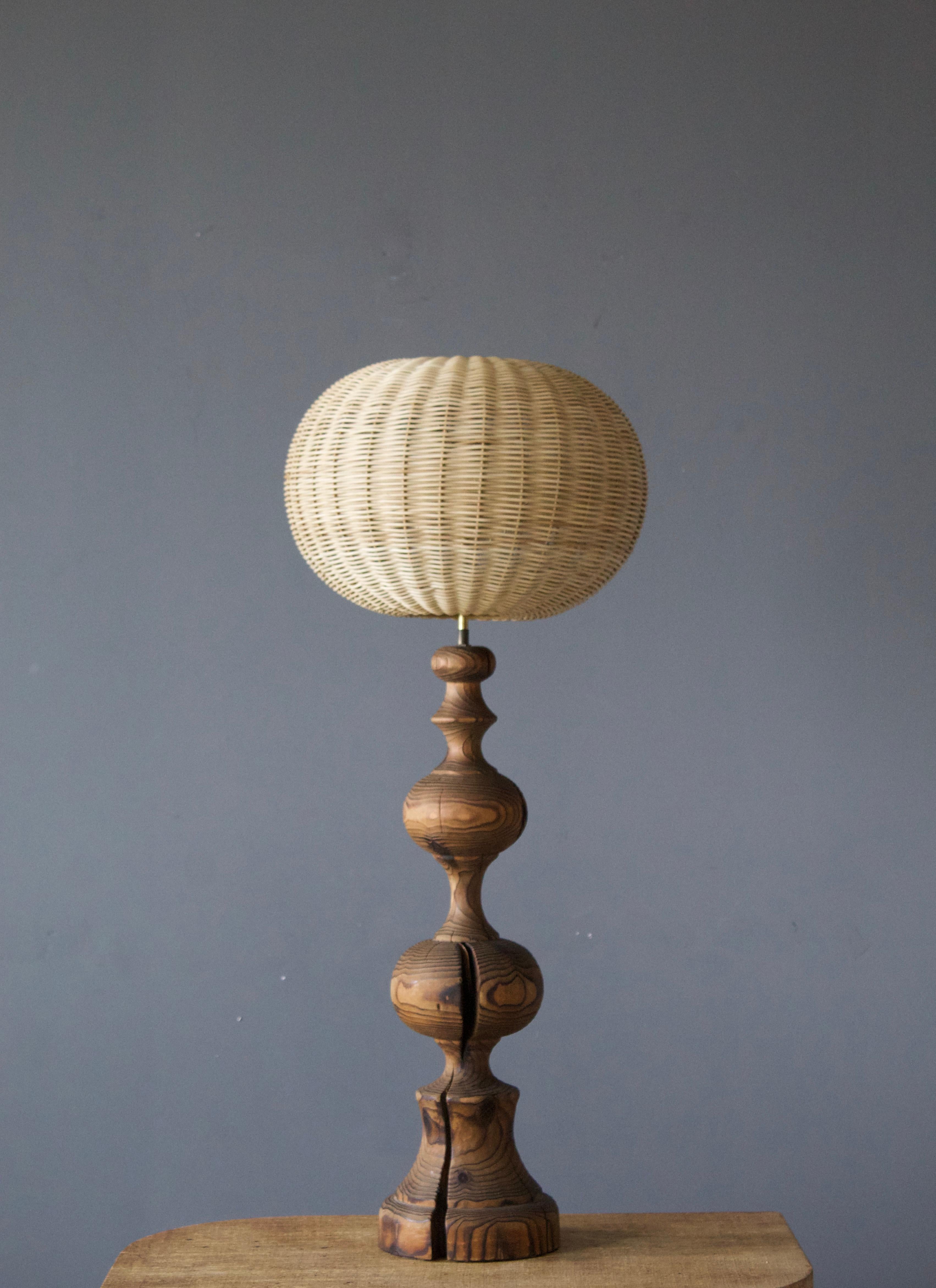 A table lamp, produced in Italy, 1970s. Finely turned solid pine.

Stated dimensions exclude lampshade, height includes socket. Illustrated model rattan lampshade can be included in purchase upon request.

Other designers of the period include
